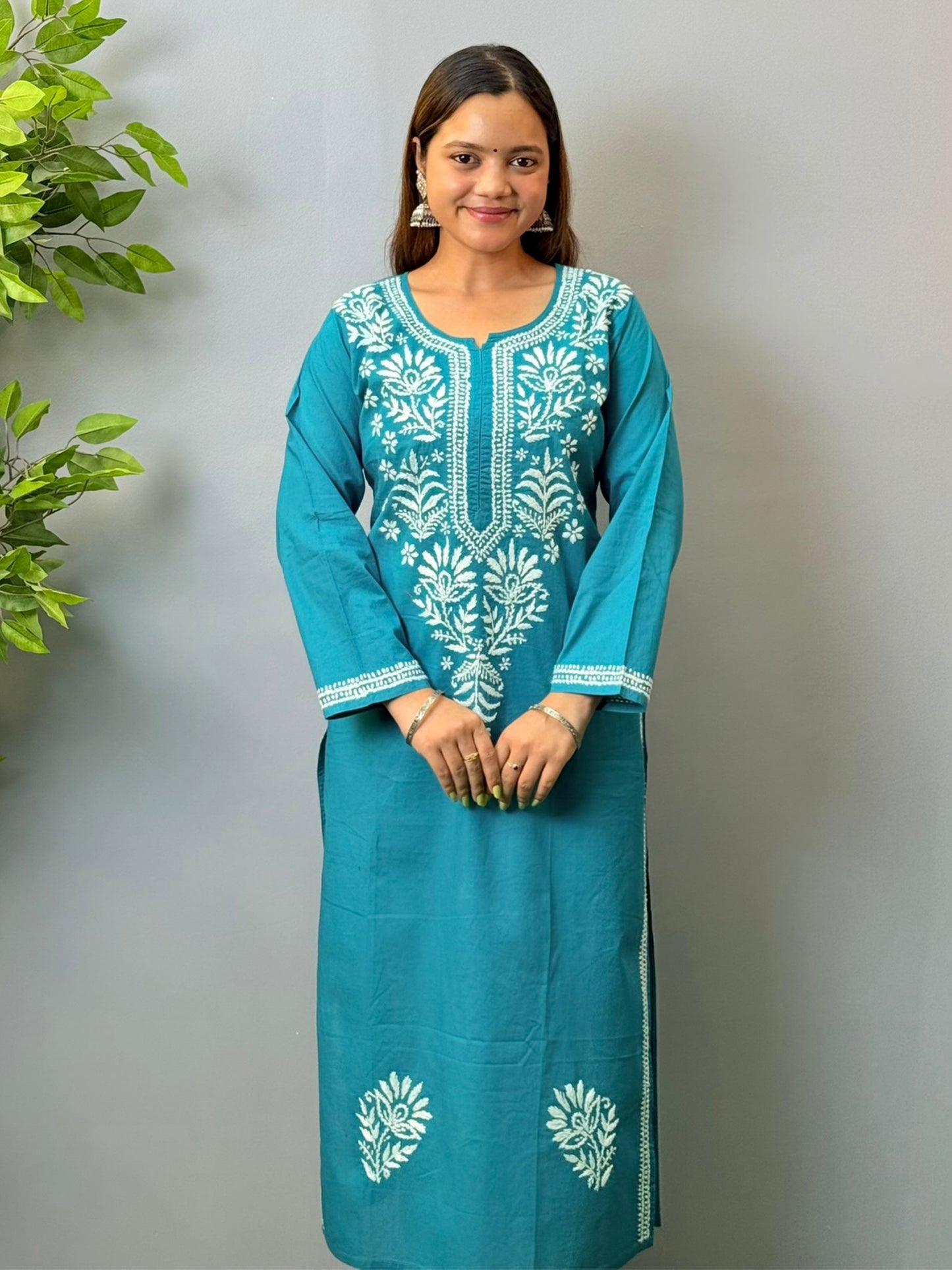 Woman wearing teal blue cotton chikankari kurta with white thread embroidery