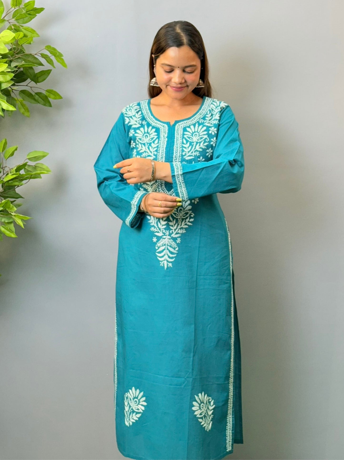 Woman wearing teal blue cotton chikankari kurta with white thread embroidery