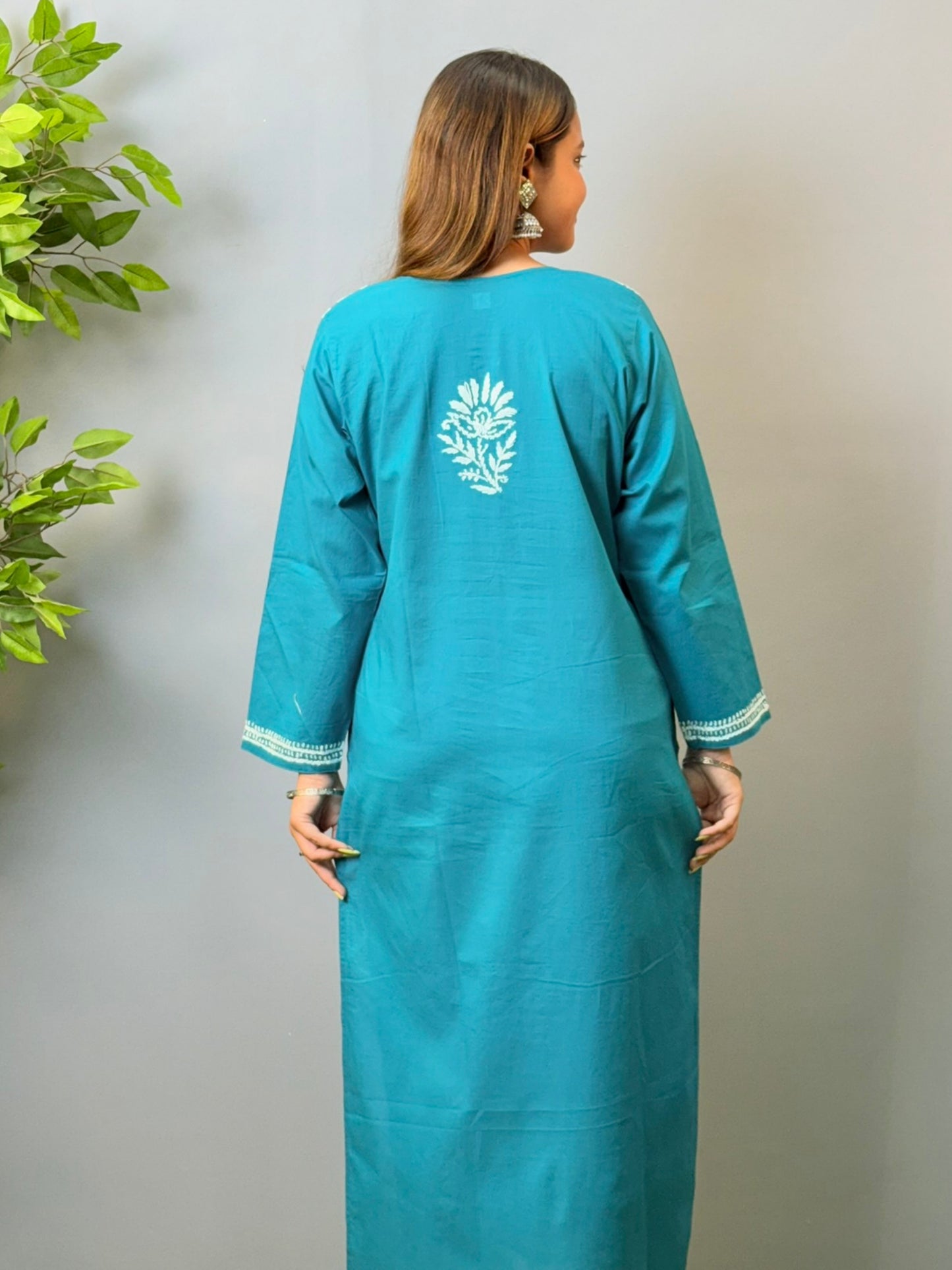 Woman wearing teal blue cotton chikankari kurta with white thread embroidery