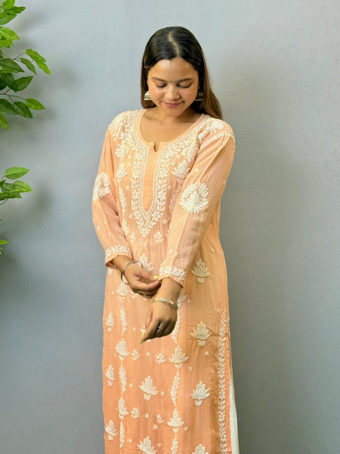 Woman wearing peach ombré viscose Chikankari kurta with white embroidery
