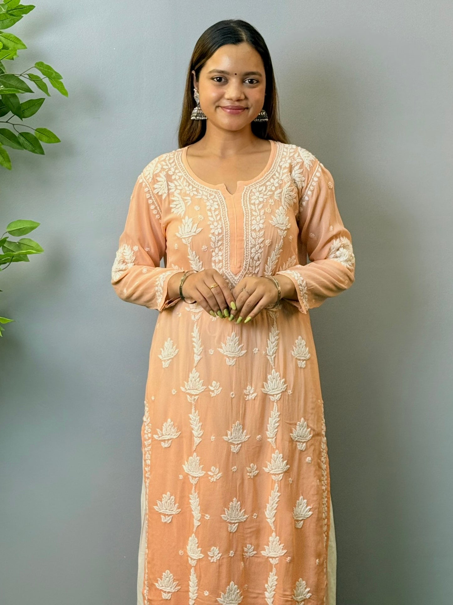 Woman wearing peach ombré viscose Chikankari kurta with white embroidery
