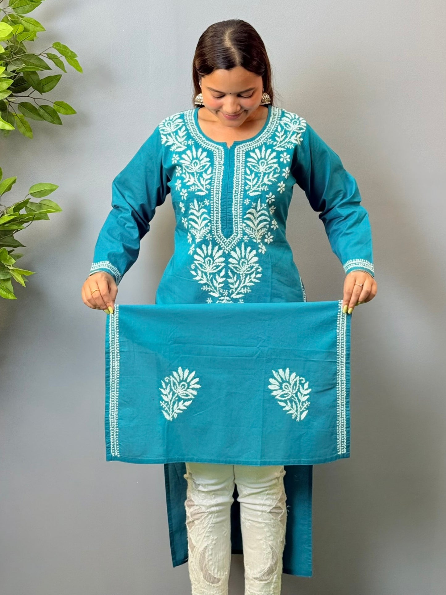 Woman wearing teal blue cotton chikankari kurta with white thread embroidery