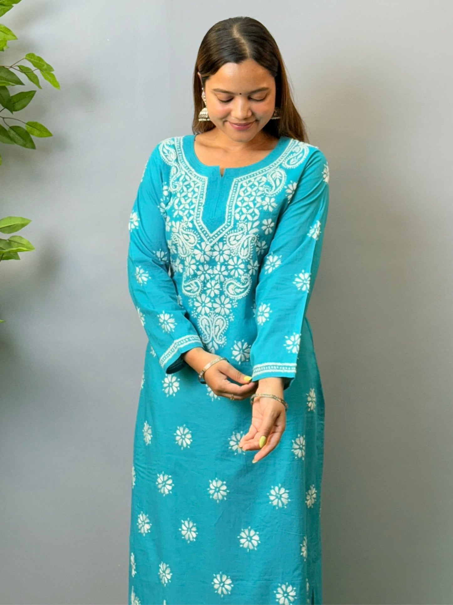 Woman in turquoise blue cotton chikankari kurta with white embroidery