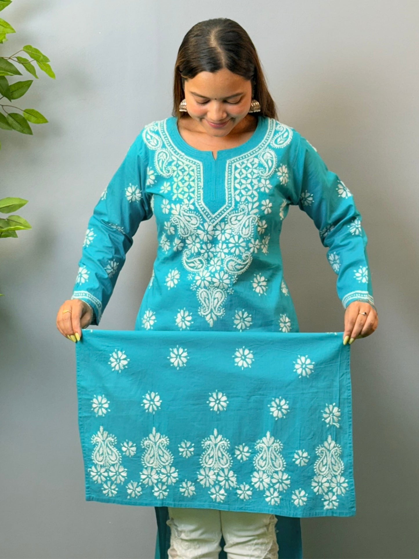 Woman in turquoise blue cotton chikankari kurta with white embroidery