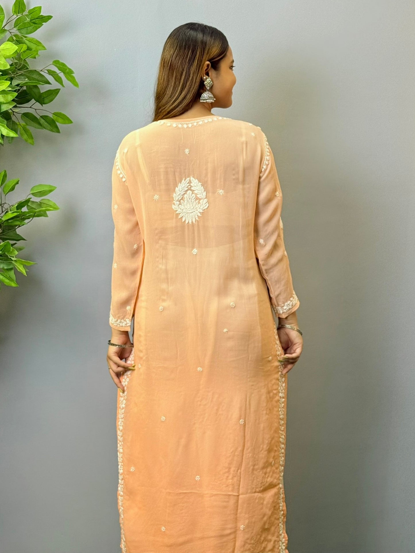 Woman wearing peach ombré viscose Chikankari kurta with white embroidery