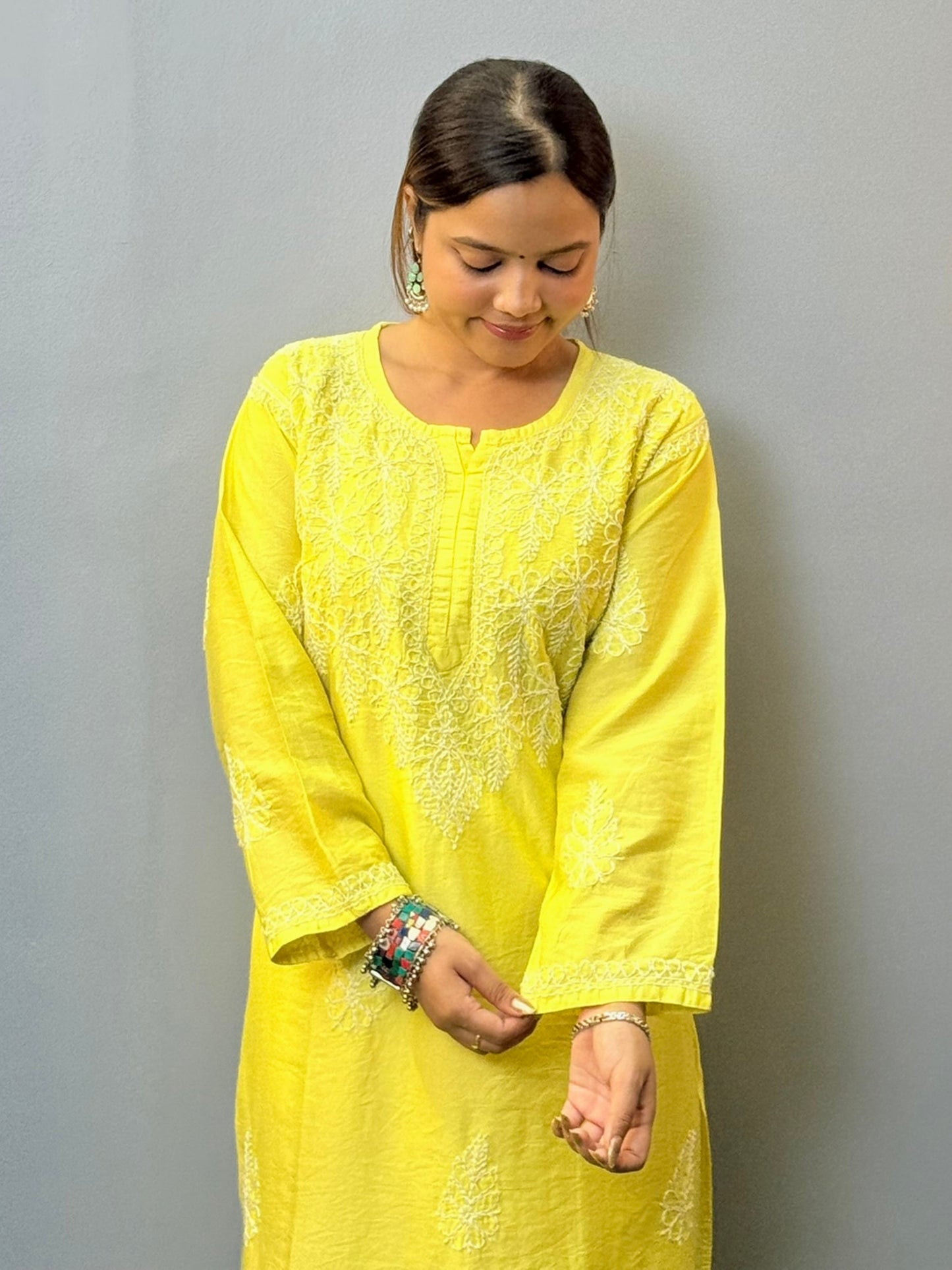 Woman wearing lime yellow chanderi chikankari kurta with bakhiya embroidery