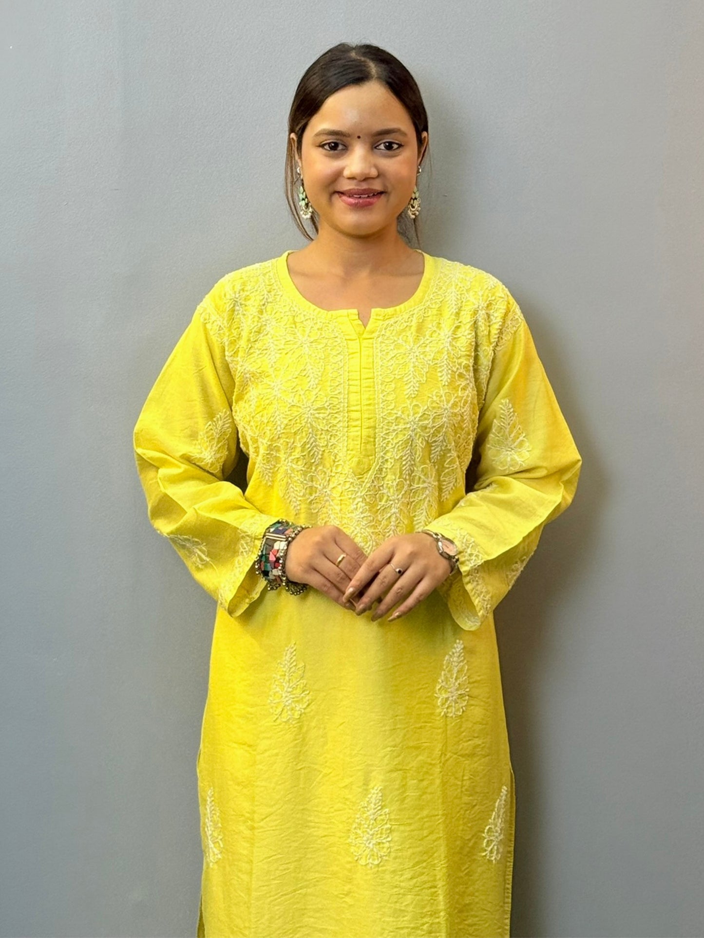 Woman wearing lime yellow chanderi chikankari kurta with bakhiya embroidery