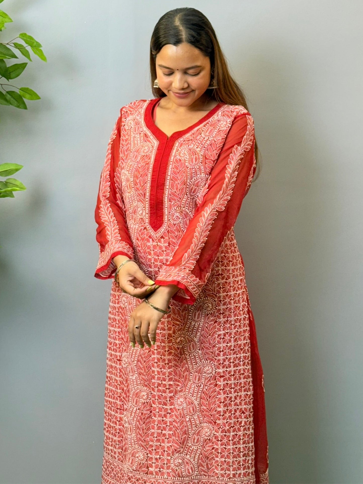 Woman wearing tomato red georgette chikankari kurta with heavy white embroidery