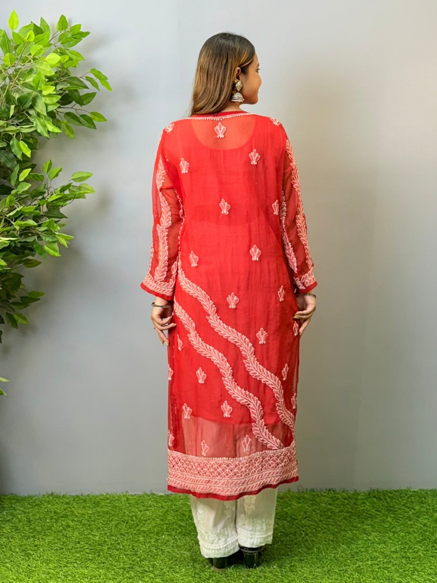 Woman wearing tomato red georgette chikankari kurta with heavy white embroidery