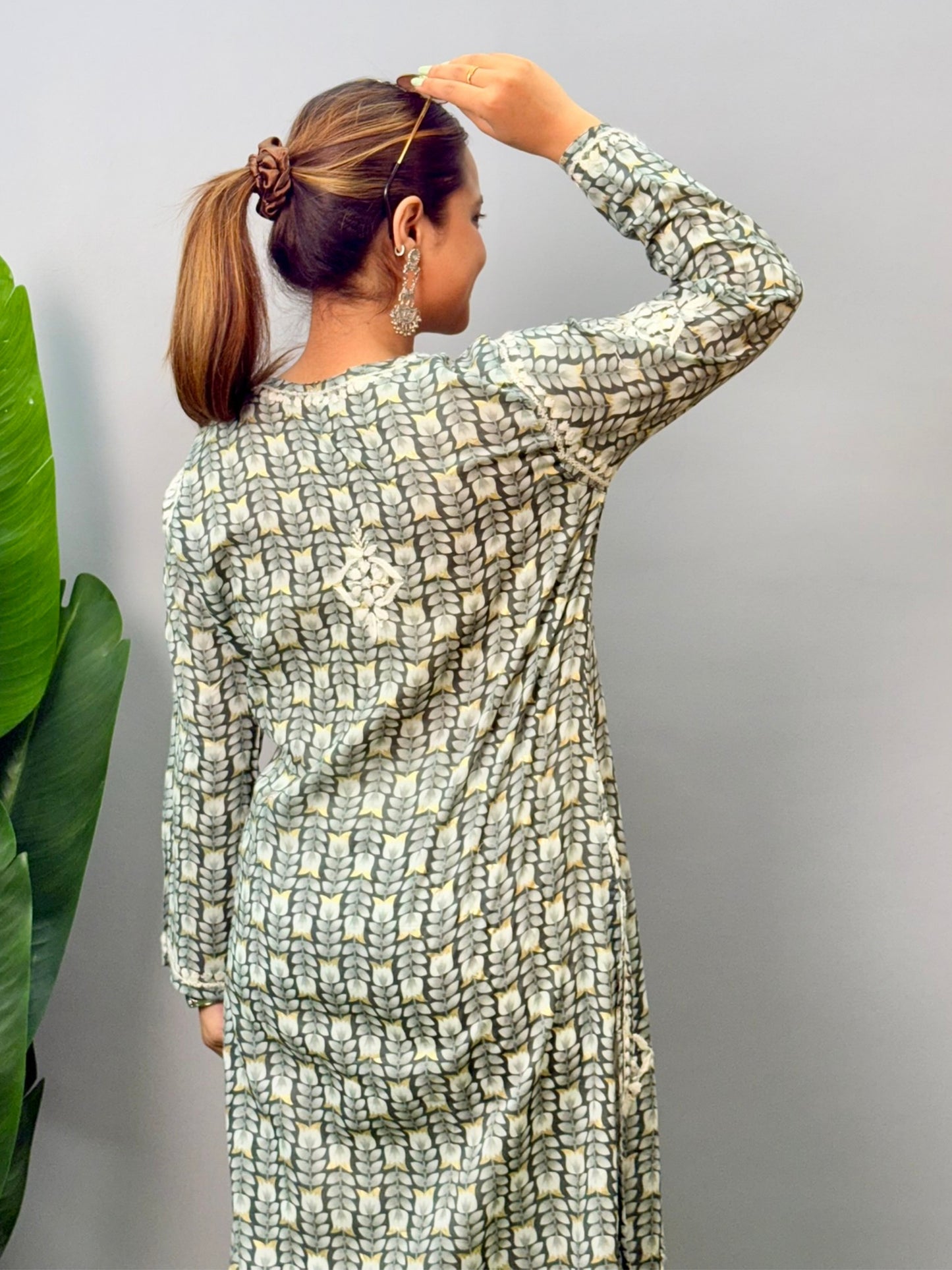 Model wearing olive grey printed chikankari kurta in mulmul fabric with white hand embroidery