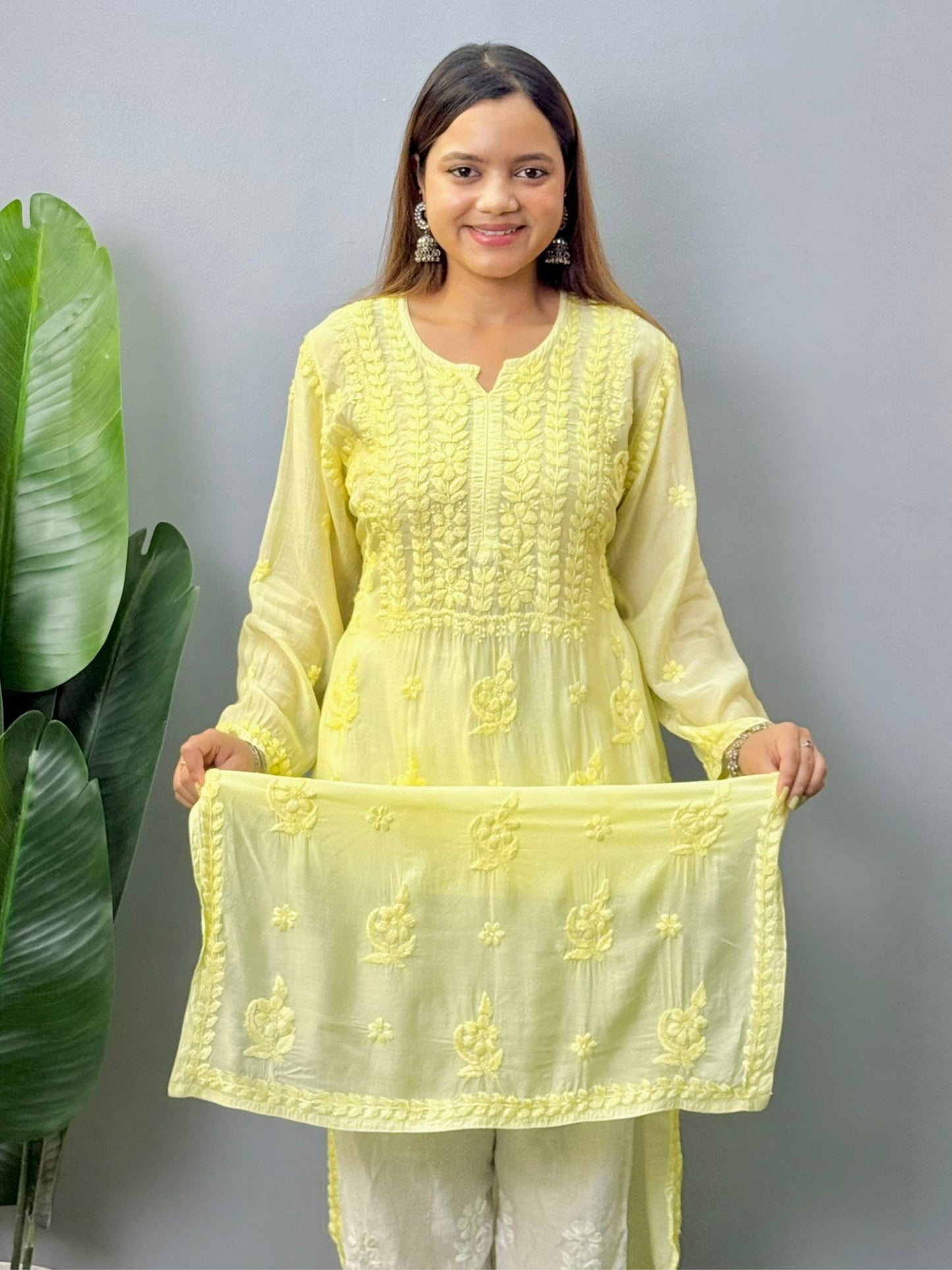 Model wearing lemon yellow muslin chikankari kurta with white pants