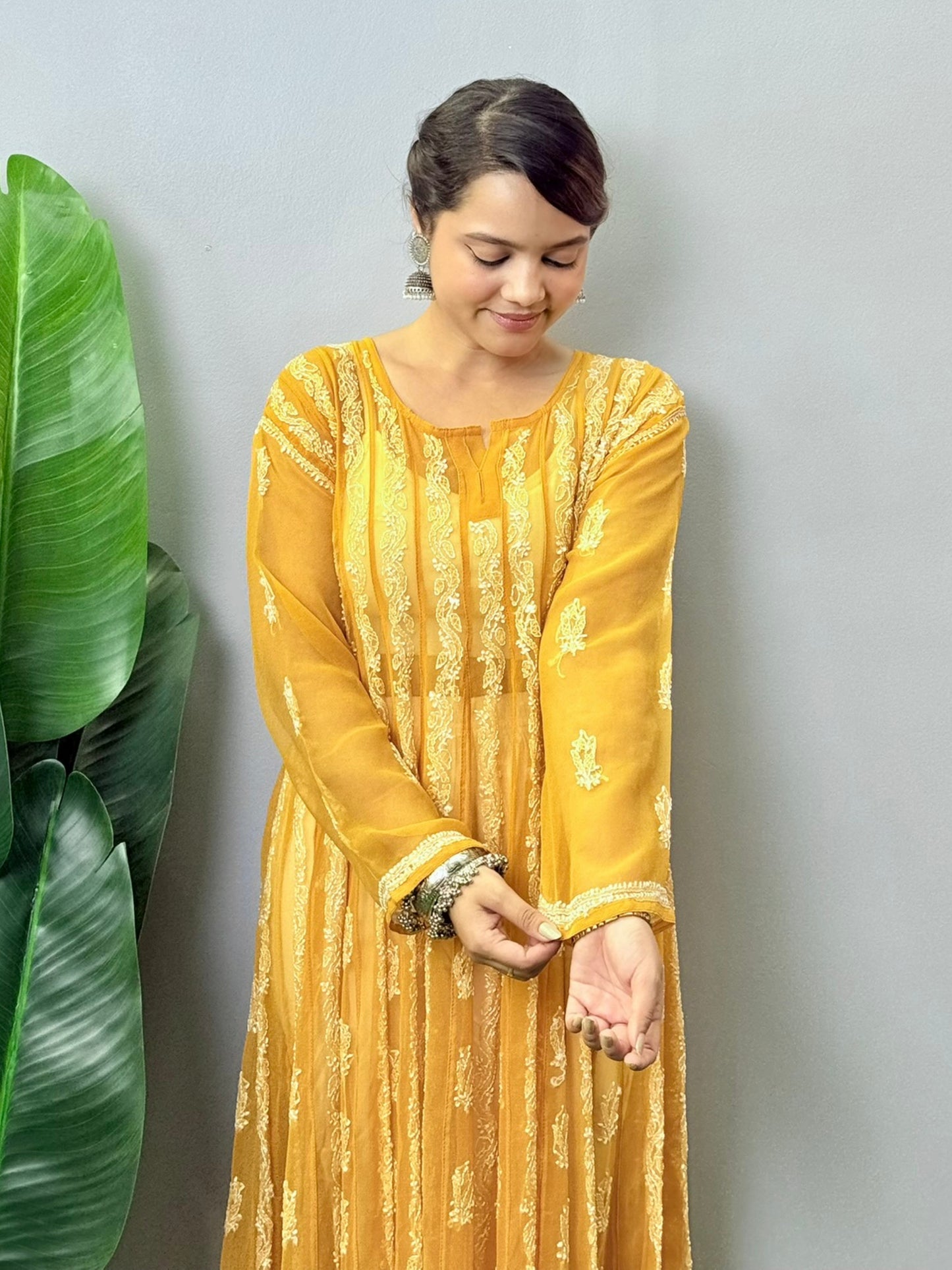 Sunshine yellow georgette long frock with heavy flair and white Lucknowi Chikankari embroidery – festive ethnic wear