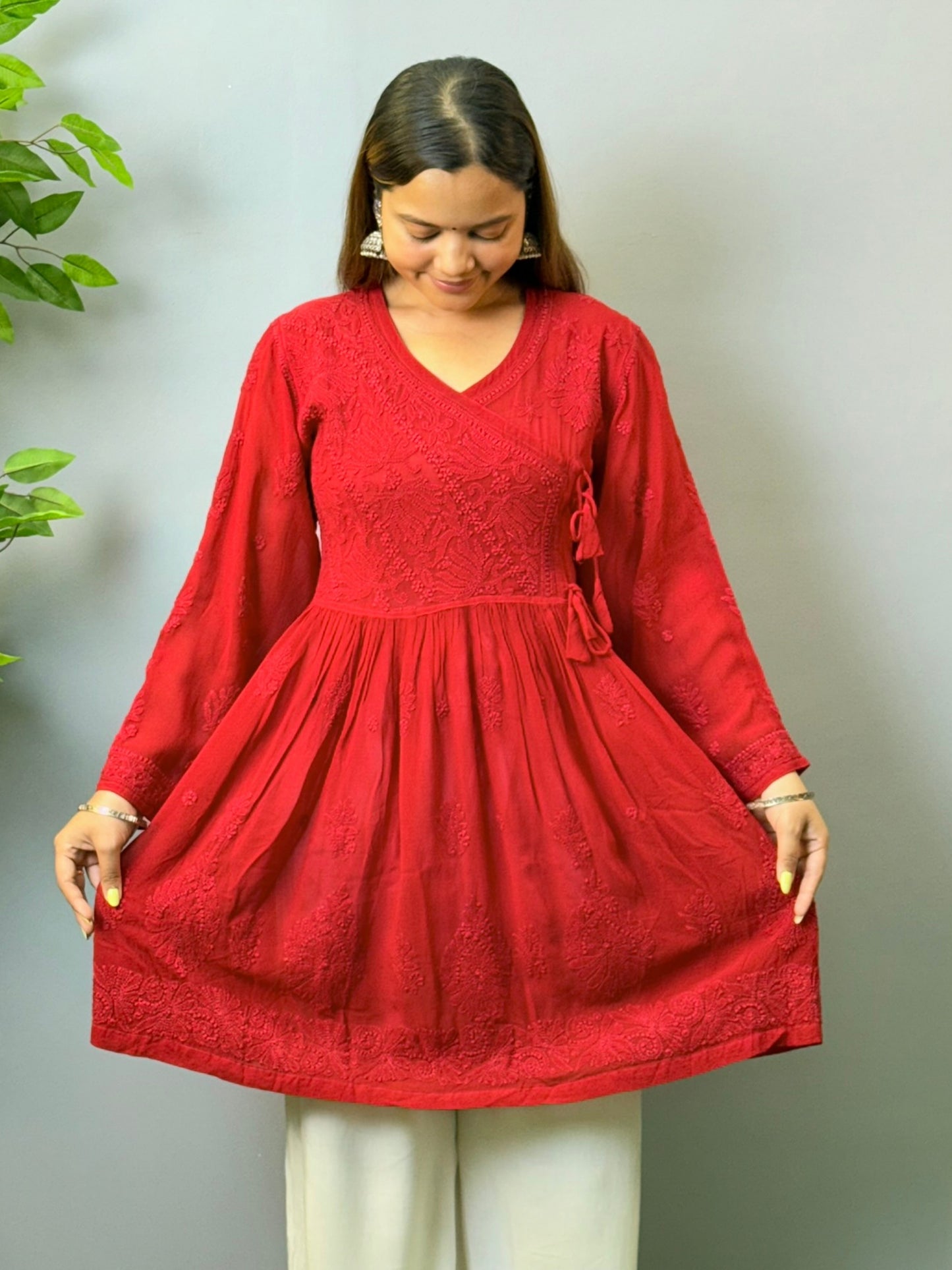 Model wearing dark red angrakha-style short chikankari kurta in viscose fabric