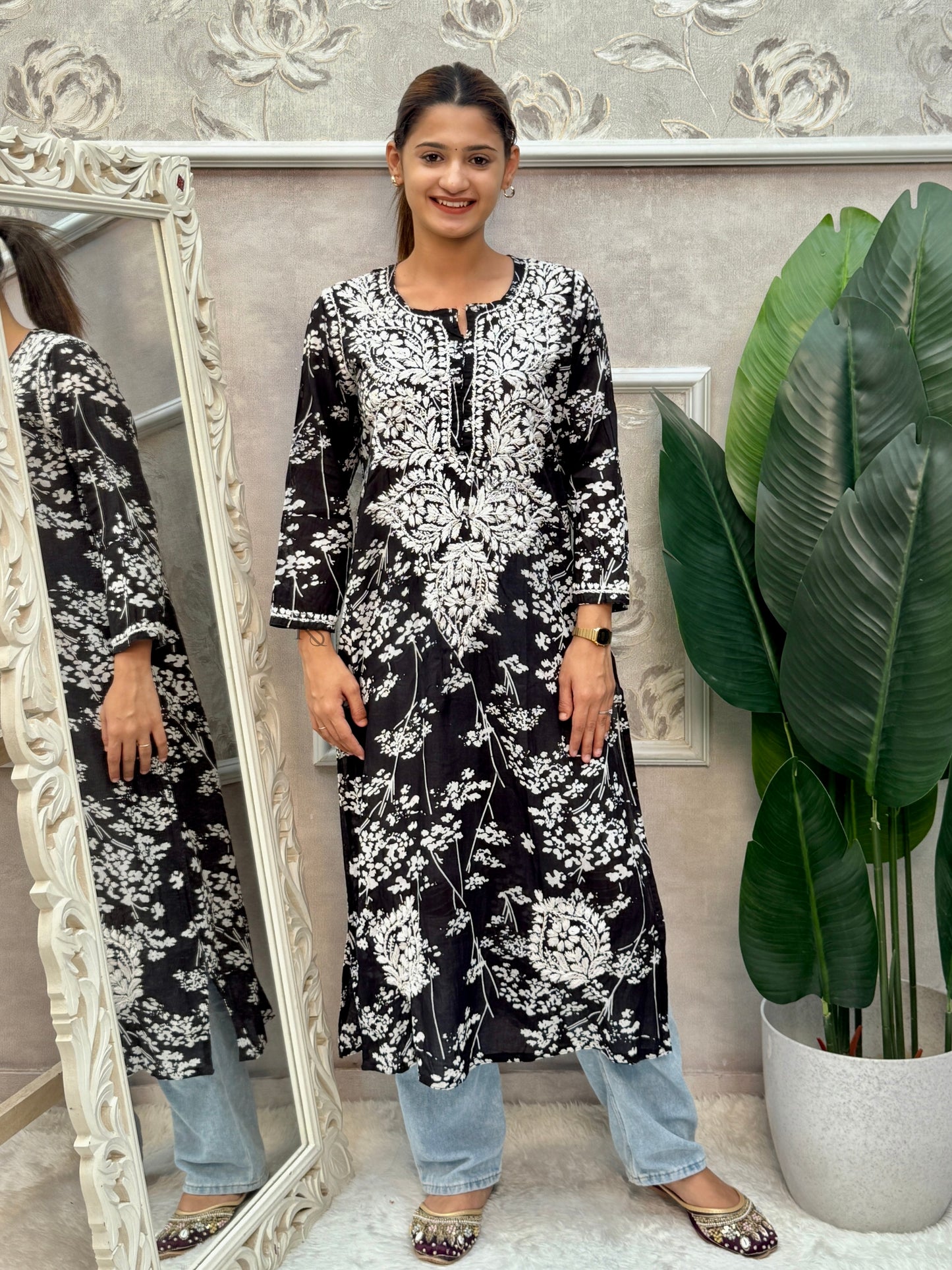 Black printed mulmul Lucknow Chikankari kurta with white floral embroidery.