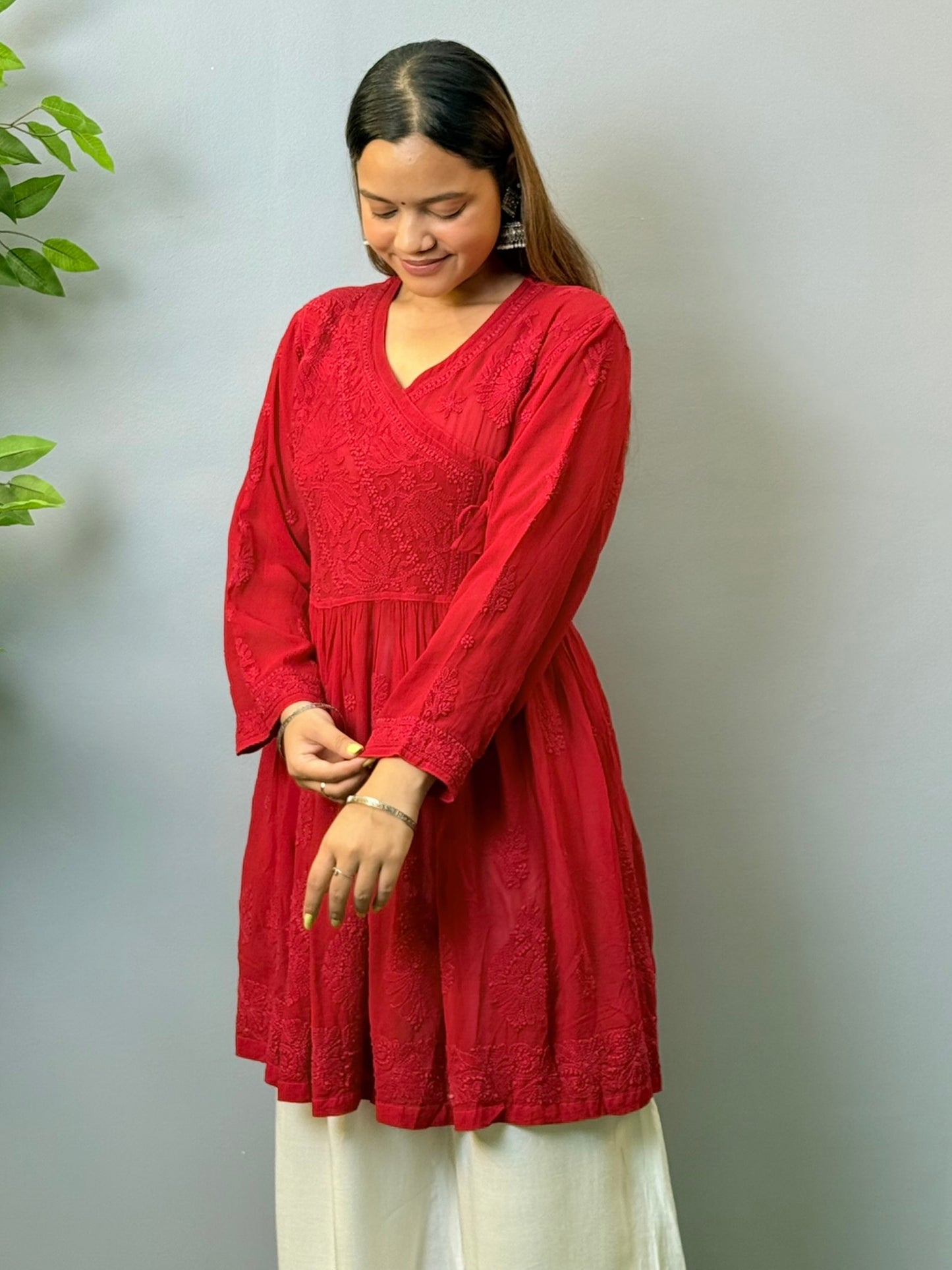 Model wearing dark red angrakha-style short chikankari kurta in viscose fabric