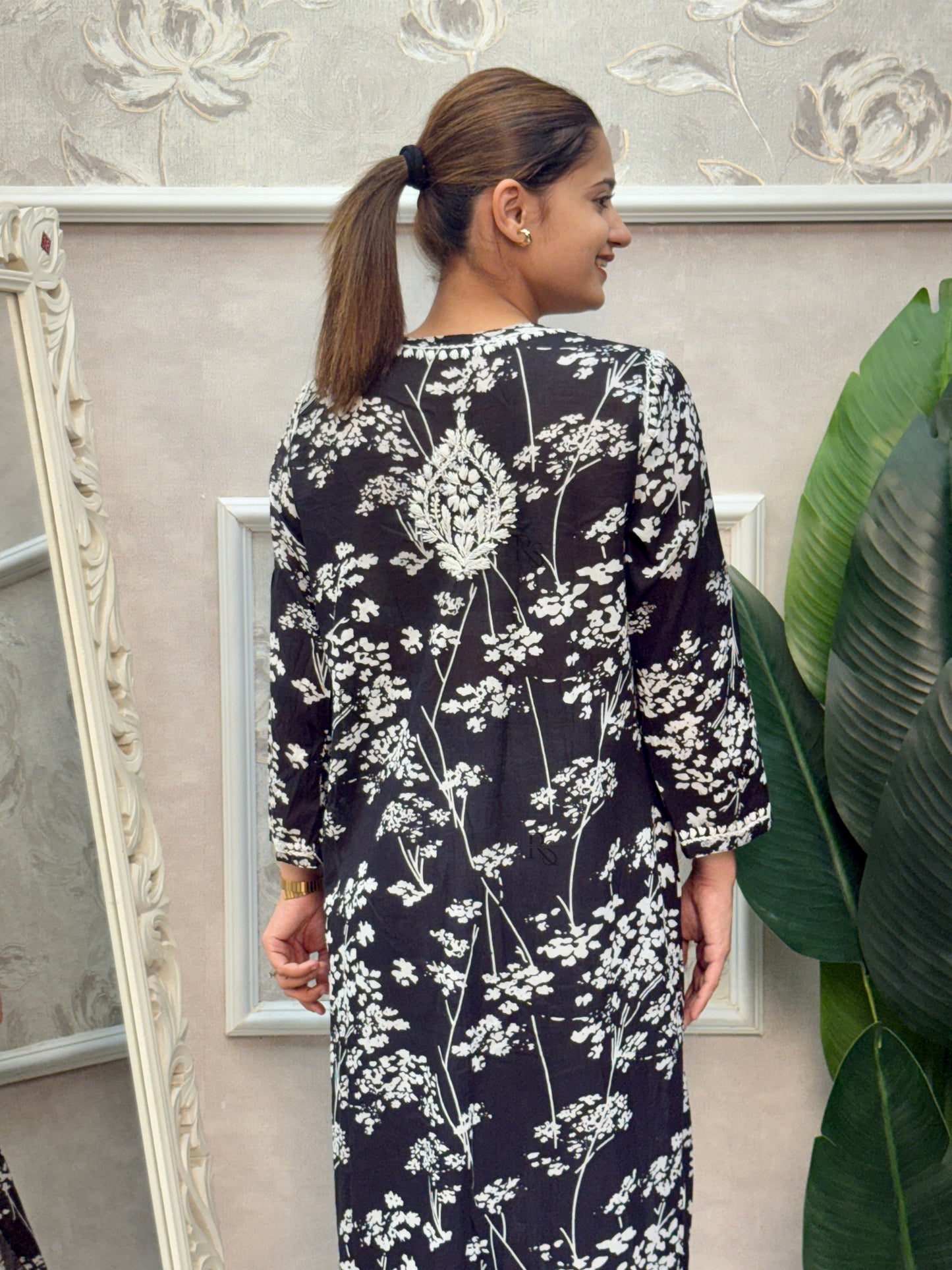 Black printed mulmul Lucknow Chikankari kurta with white floral embroidery.