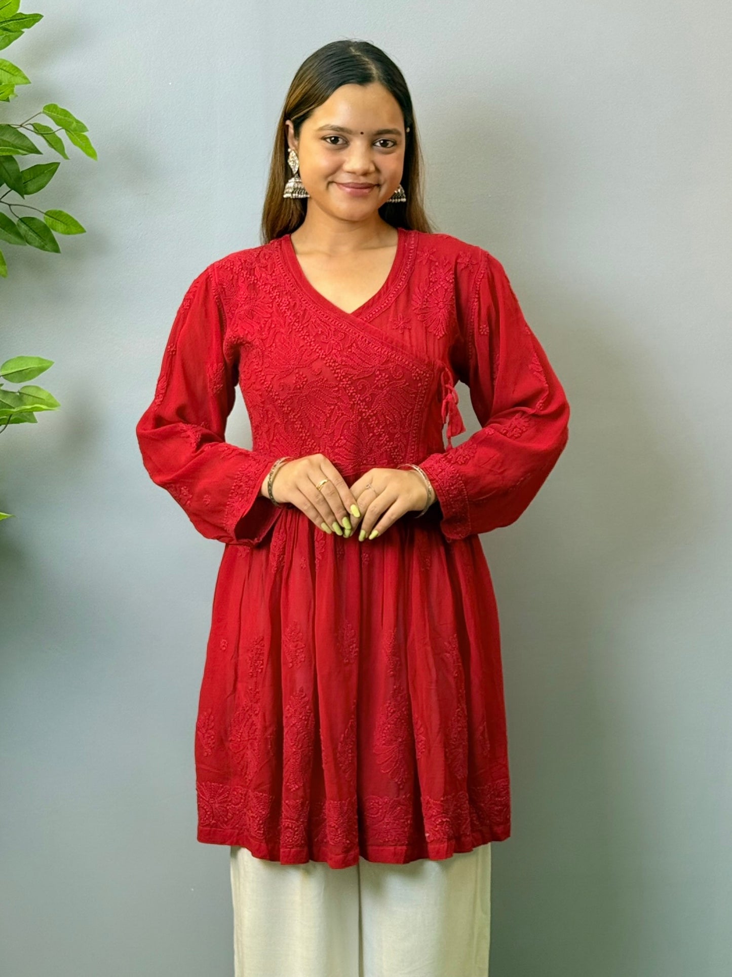 Model wearing dark red angrakha-style short chikankari kurta in viscose fabric