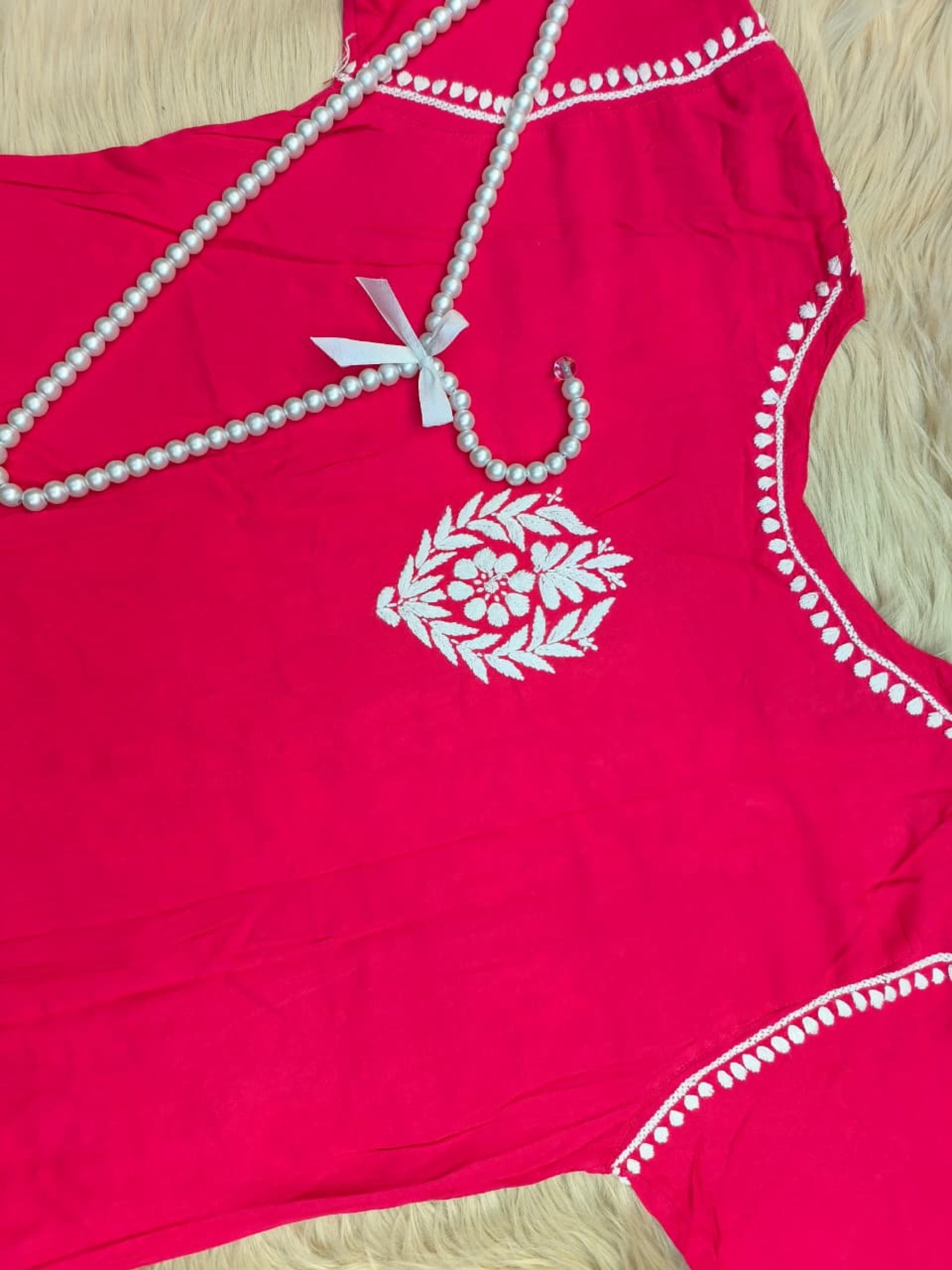 Rani pink rayon Lucknow Chikankari kurta with white hand embroidery, soft and comfortable.