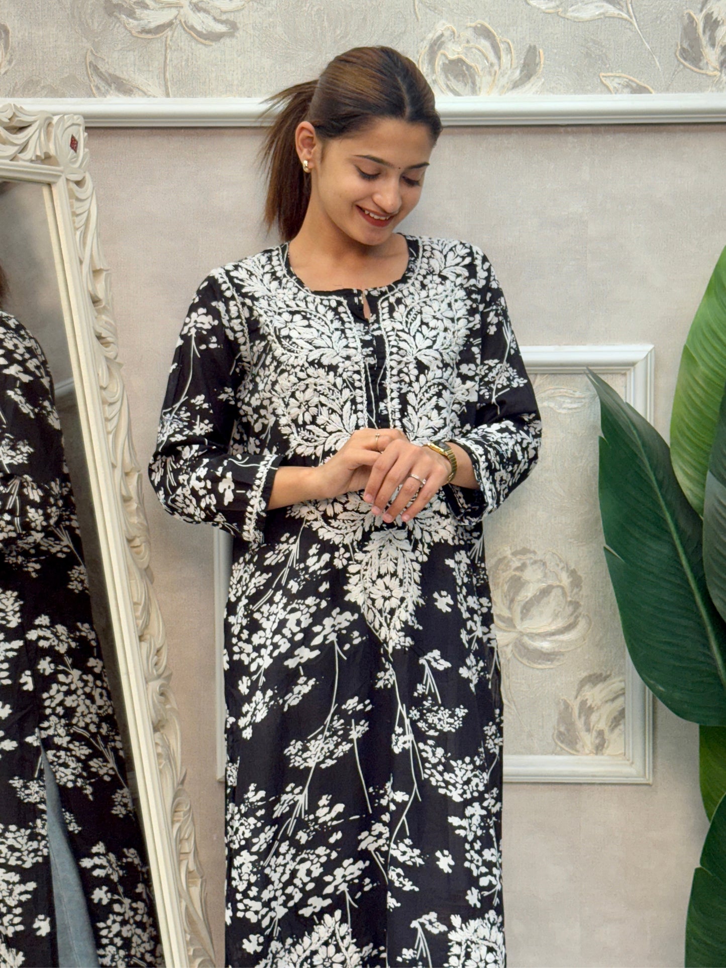 Black printed mulmul Lucknow Chikankari kurta with white floral embroidery.