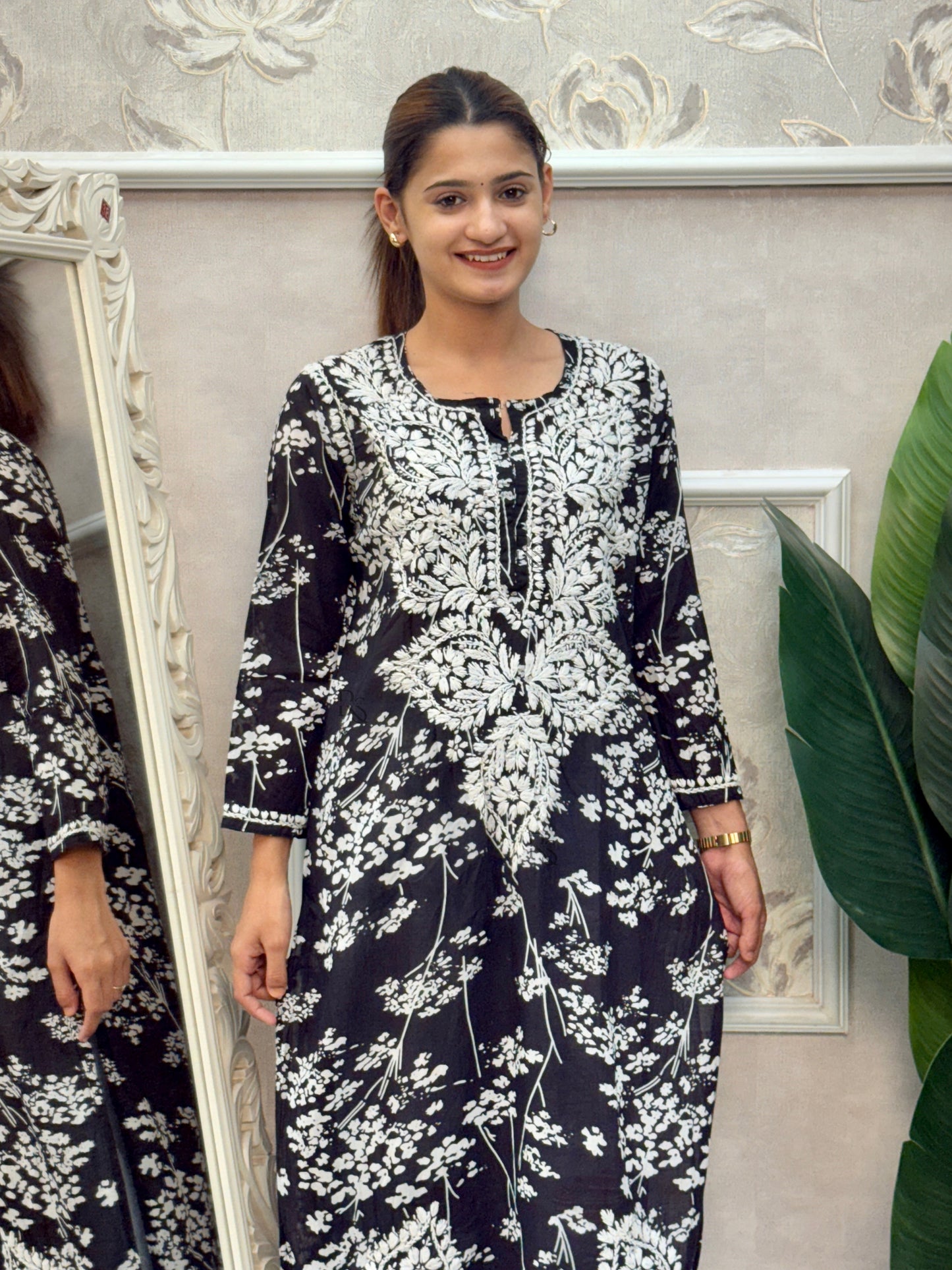 Black printed mulmul Lucknow Chikankari kurta with white floral embroidery.