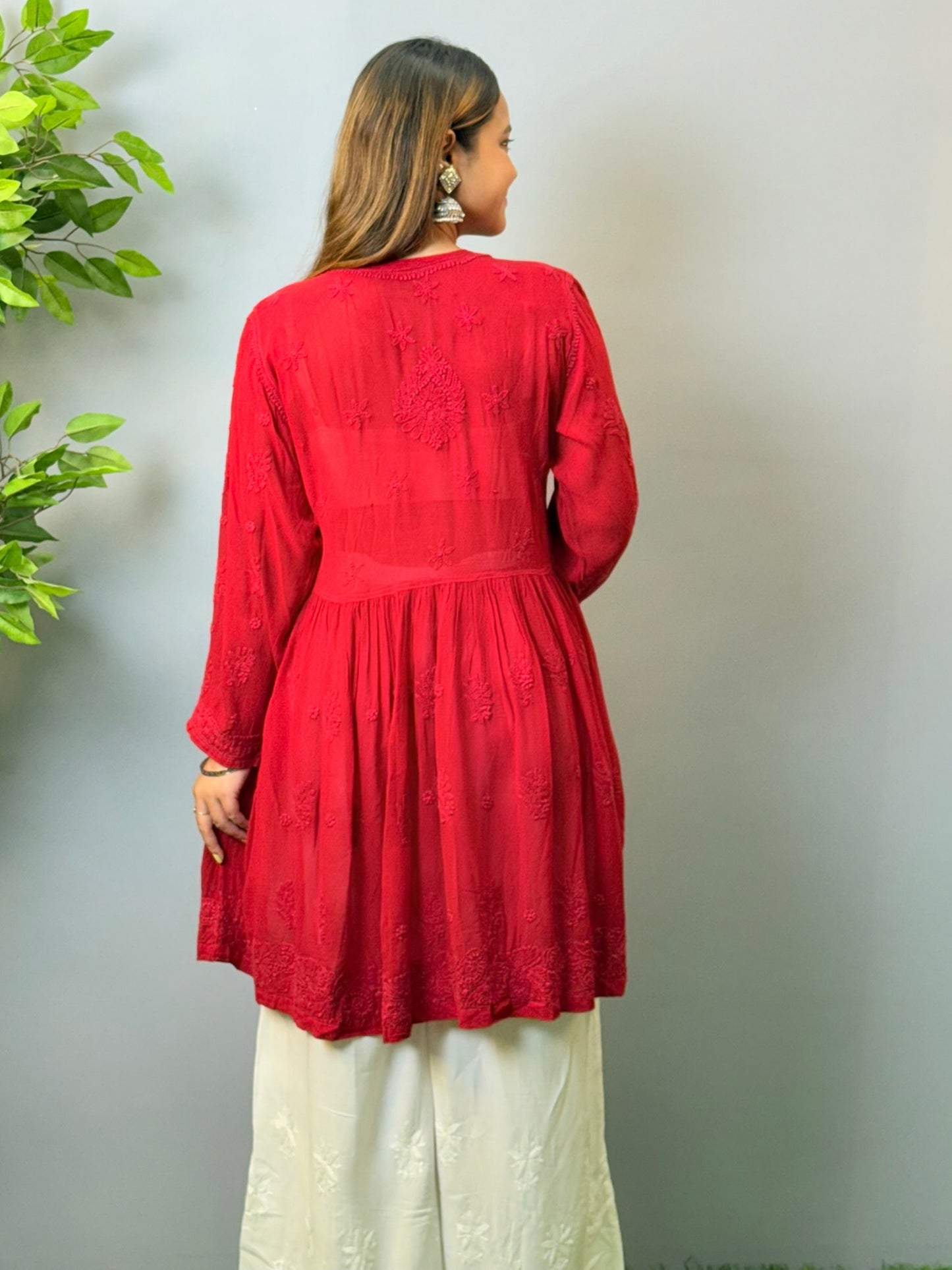 Model wearing dark red angrakha-style short chikankari kurta in viscose fabric