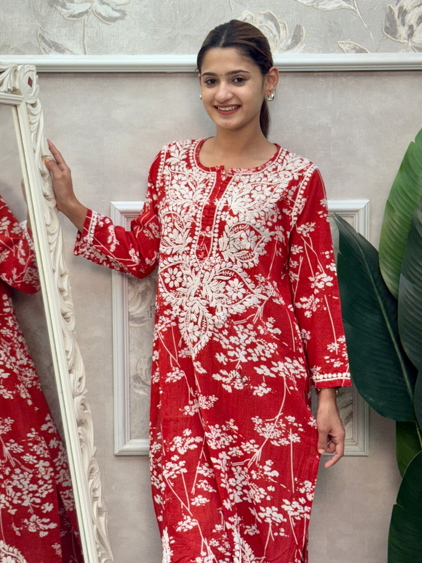 Red printed mulmul Lucknow Chikankari kurta with white floral design and hand embroidery.