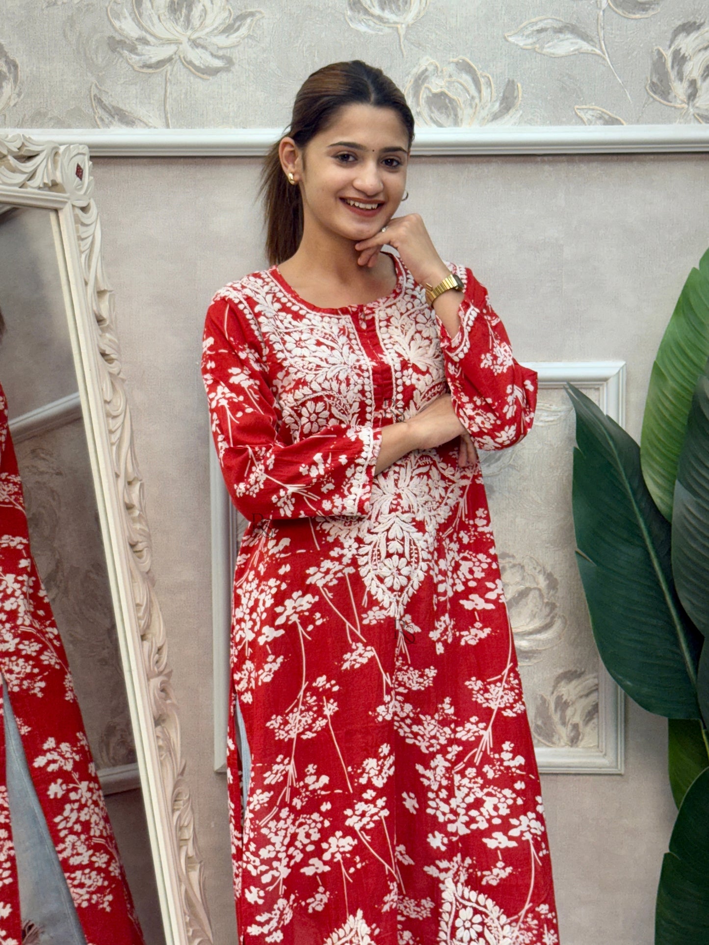 Red printed mulmul Lucknow Chikankari kurta with white floral design and hand embroidery.