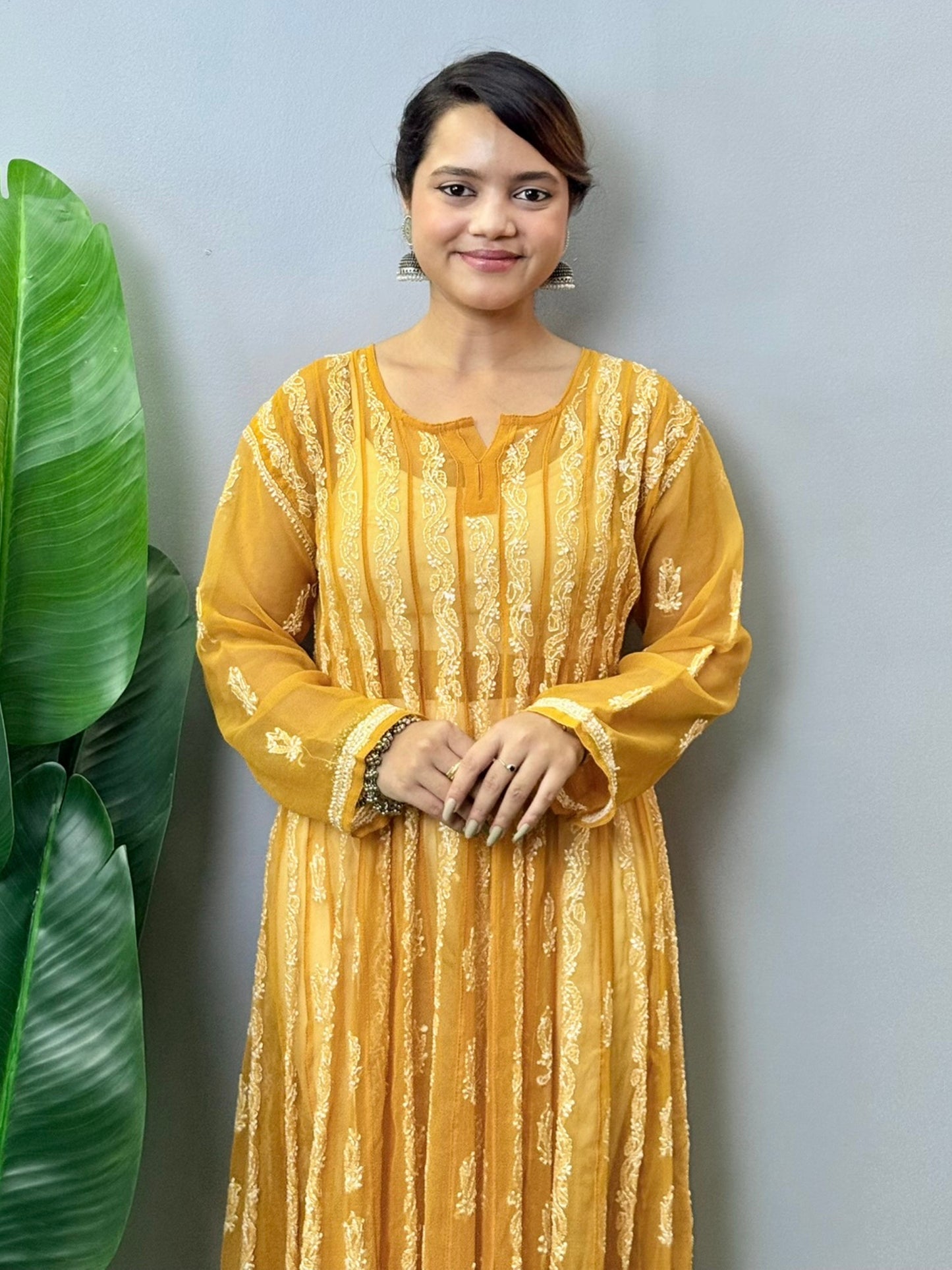 Sunshine yellow georgette long frock with heavy flair and white Lucknowi Chikankari embroidery – festive ethnic wear