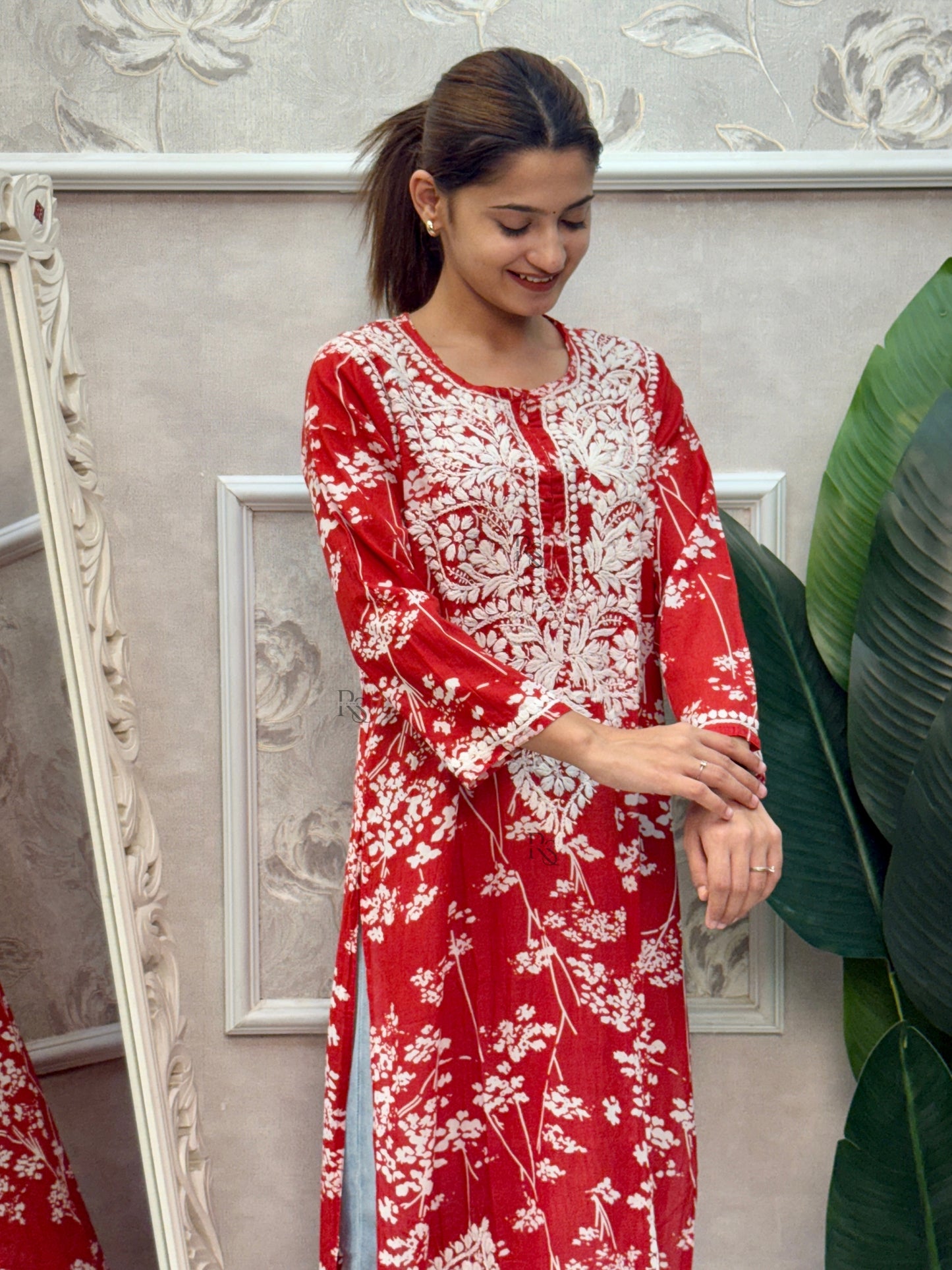 Red printed mulmul Lucknow Chikankari kurta with white floral design and hand embroidery.
