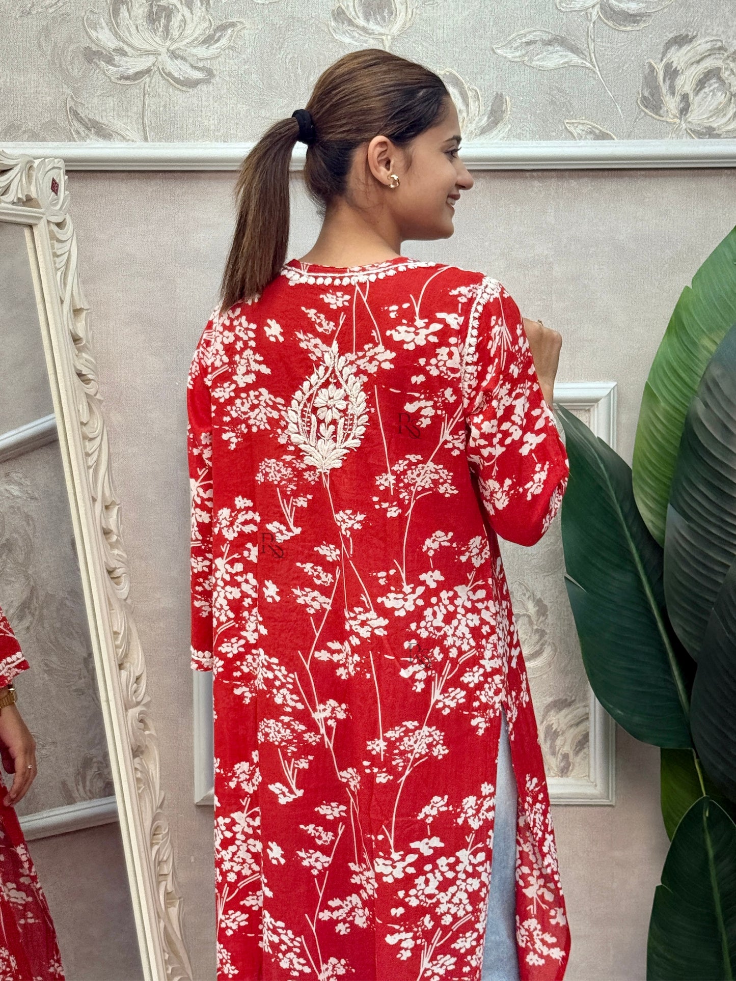 Red printed mulmul Lucknow Chikankari kurta with white floral design and hand embroidery.