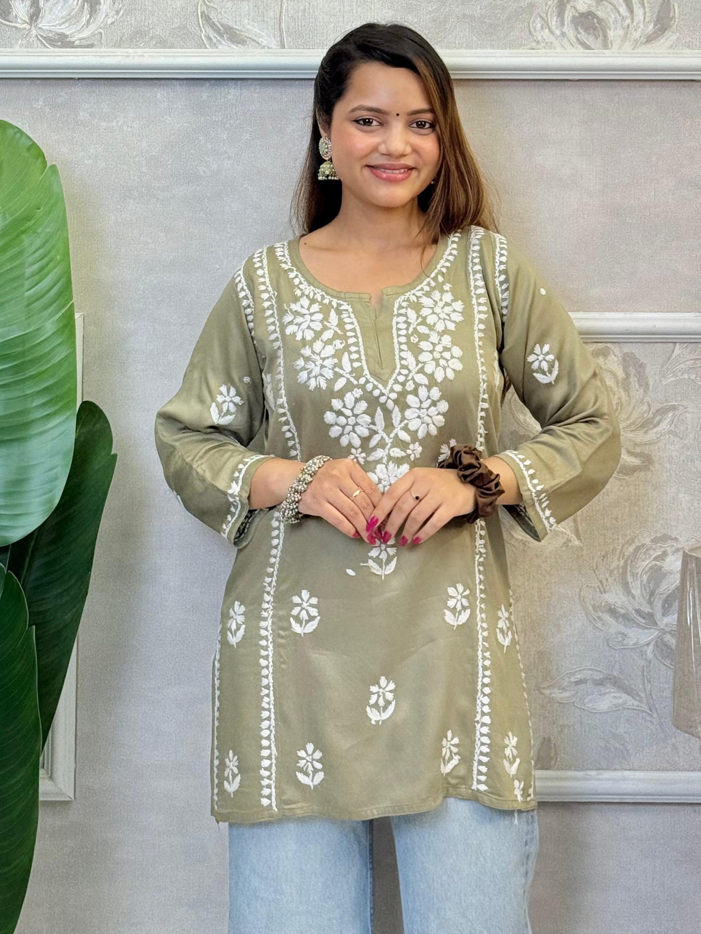 Olive green satin Lucknow Chikankari short kurta with white hand embroidery, full sleeves, and elegant floral patterns.