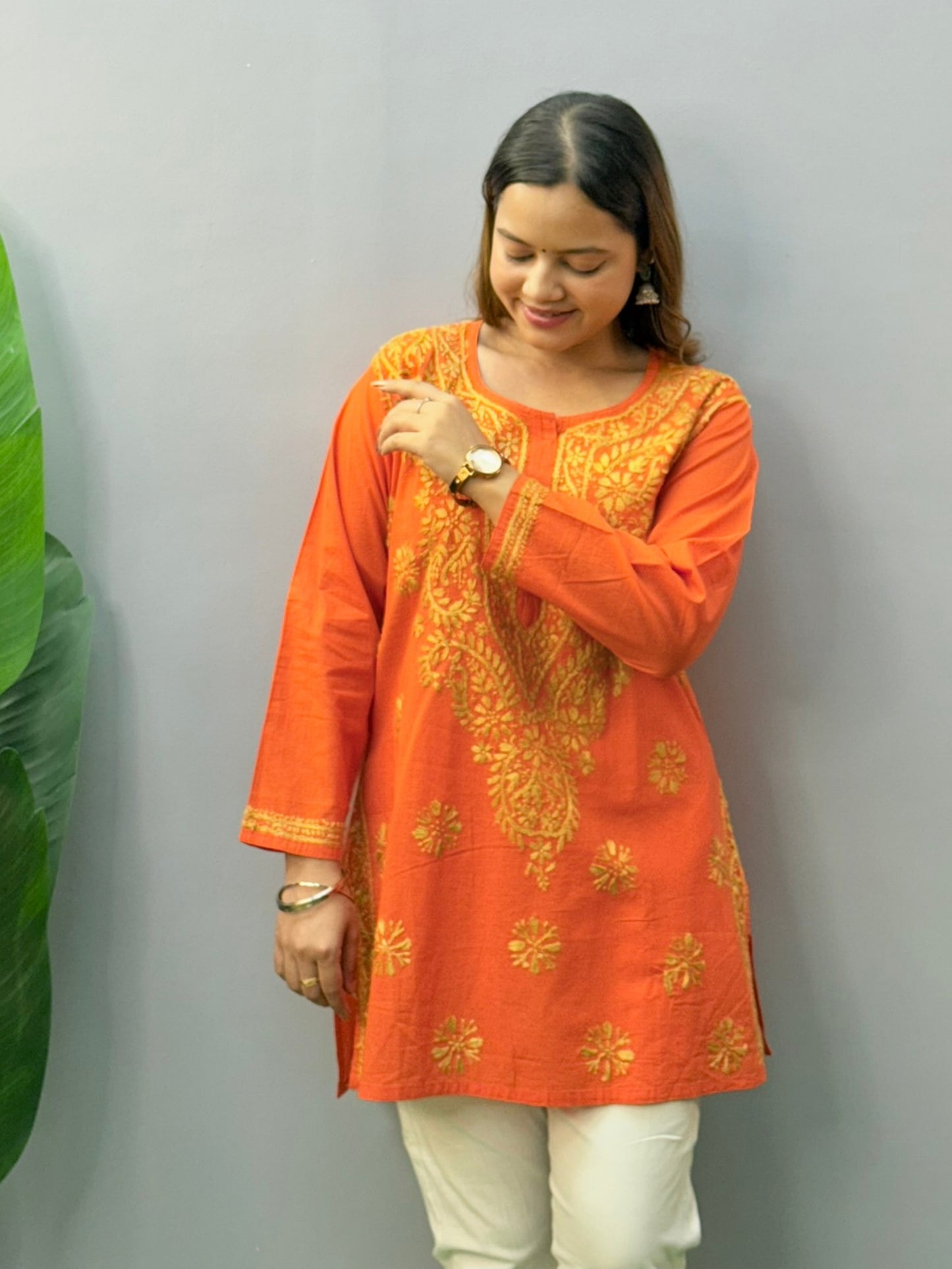 Fiery orange short cotton Chikankari kurta with golden hand embroidery, perfect for casual or everyday wear