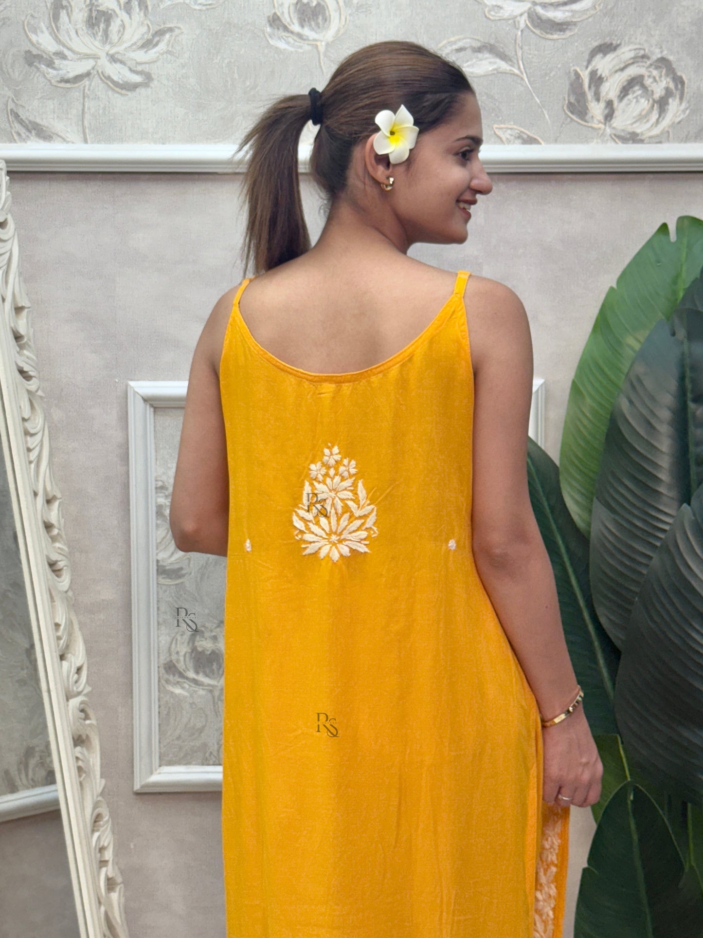 Mustard yellow sleeveless Lucknow Chikankari rayon kurta and pant set with white hand embroidery.