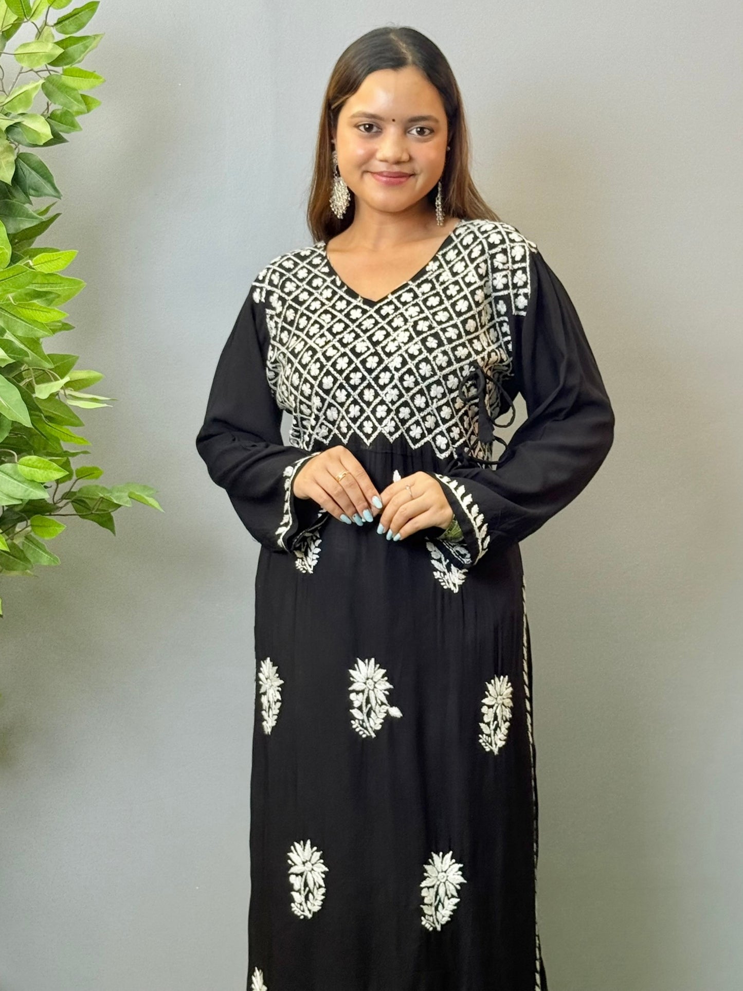 Model wearing a black modal angrakha kurta with elegant white chikankari embroidery and straight silhouette.