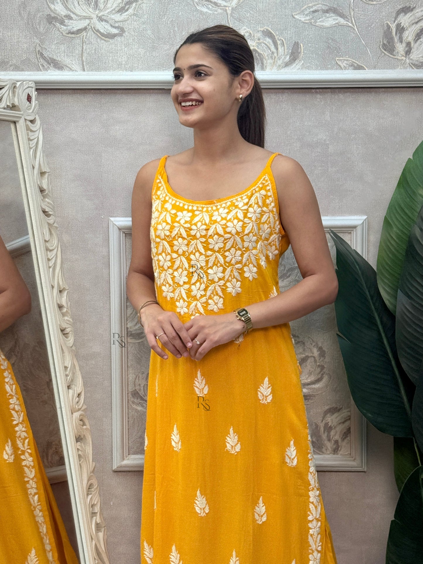 Mustard yellow sleeveless Lucknow Chikankari rayon kurta and pant set with white hand embroidery.