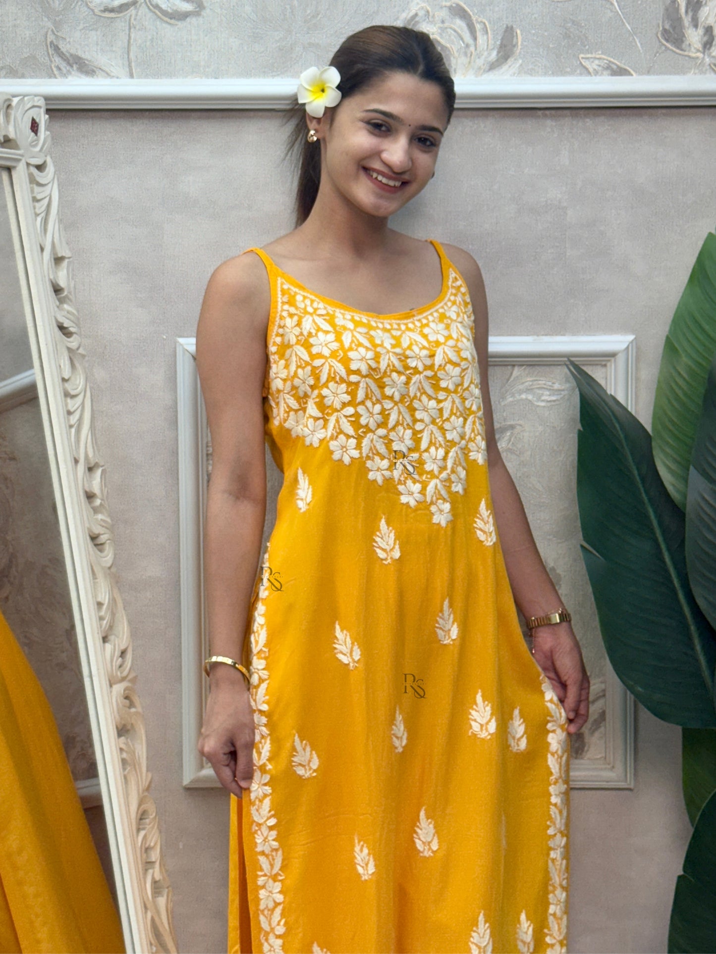 Mustard yellow sleeveless Lucknow Chikankari rayon kurta and pant set with white hand embroidery.