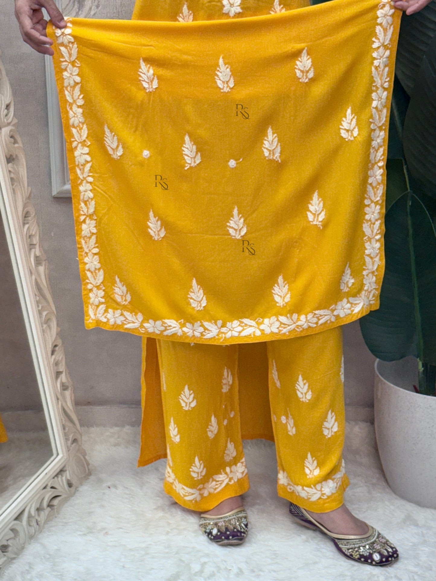 Mustard yellow sleeveless Lucknow Chikankari rayon kurta and pant set with white hand embroidery.