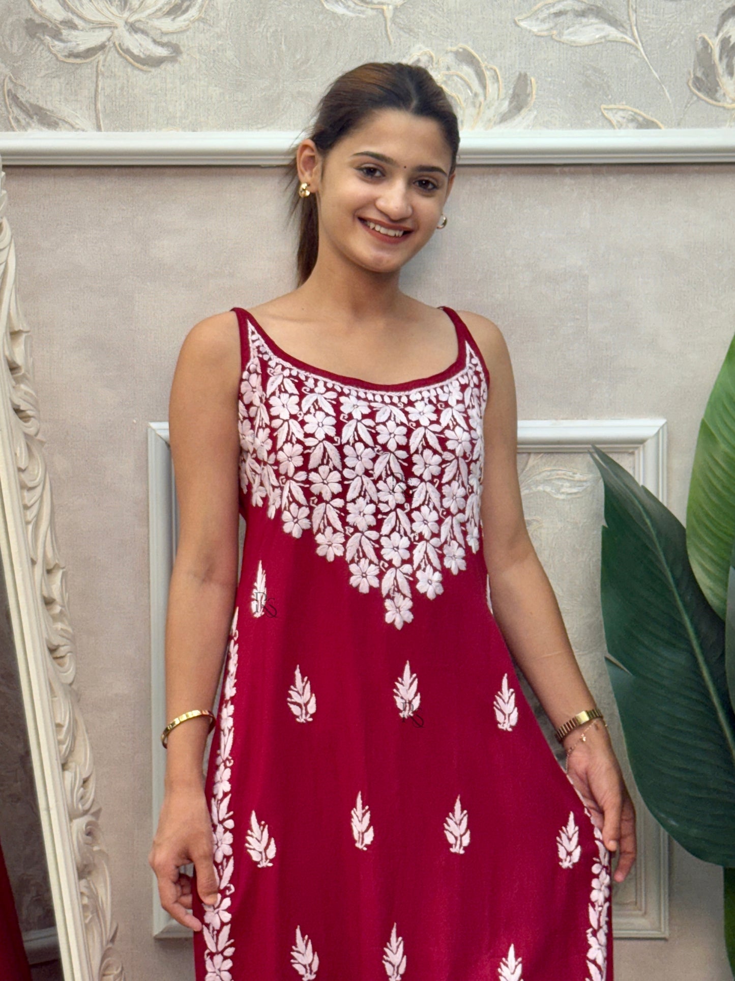 Deep maroon sleeveless Lucknow Chikankari rayon kurta and pant set with white hand embroidery.