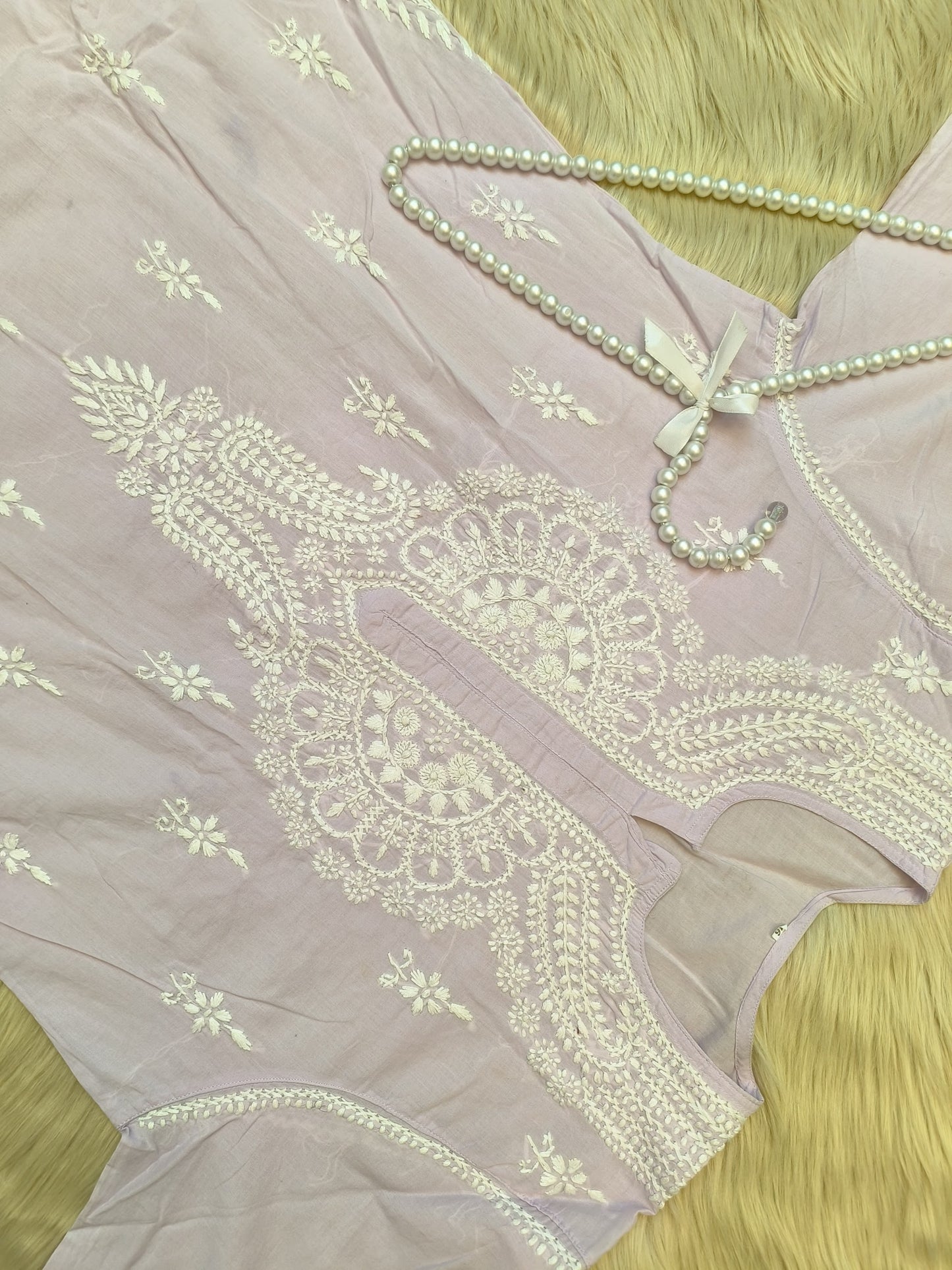 Lavender cotton chikankari kurta and palazzo set with hand embroidery, laid flat on fur background