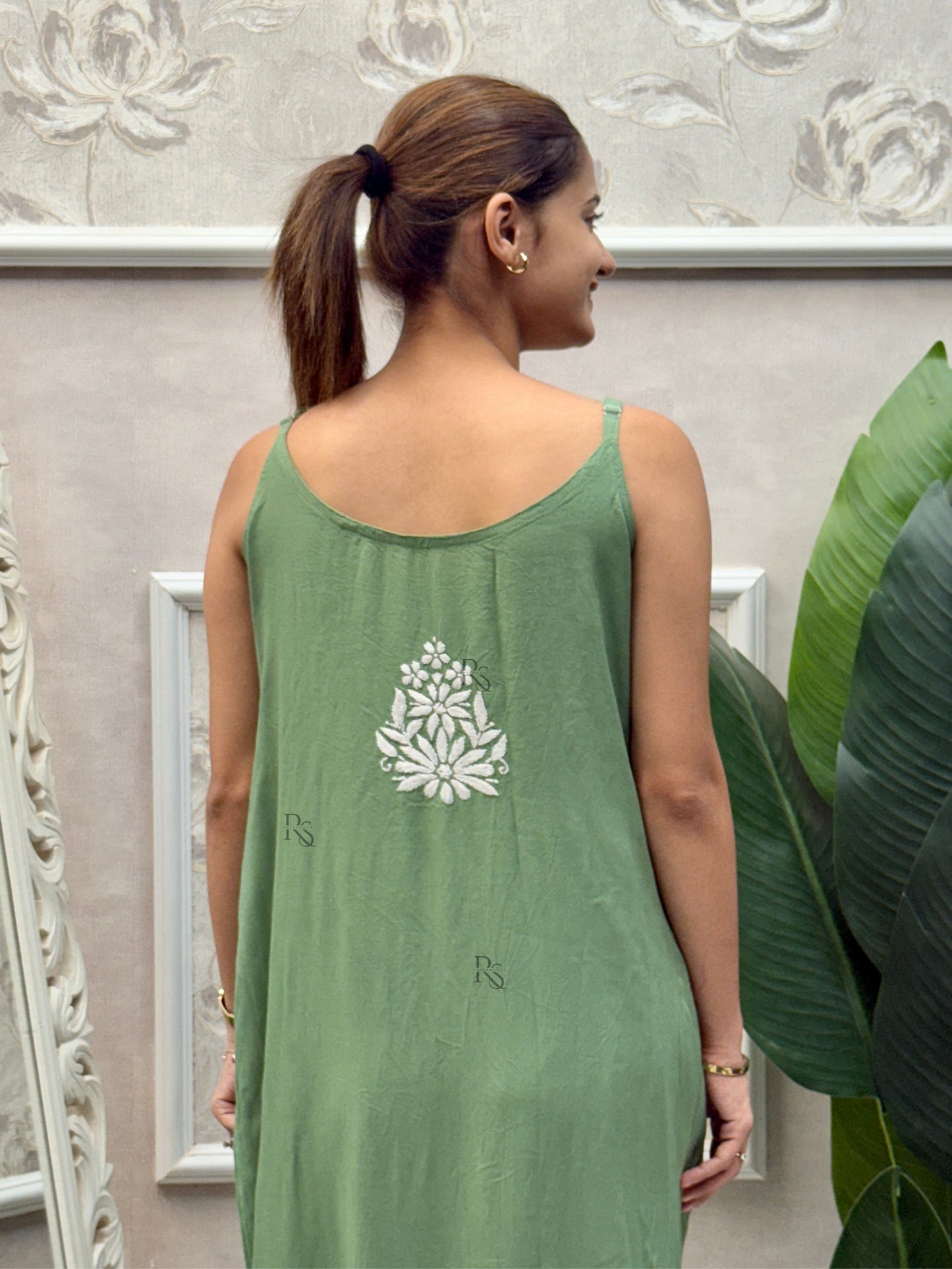 Sage green sleeveless Lucknow Chikankari rayon kurta and pant set with white hand embroidery.