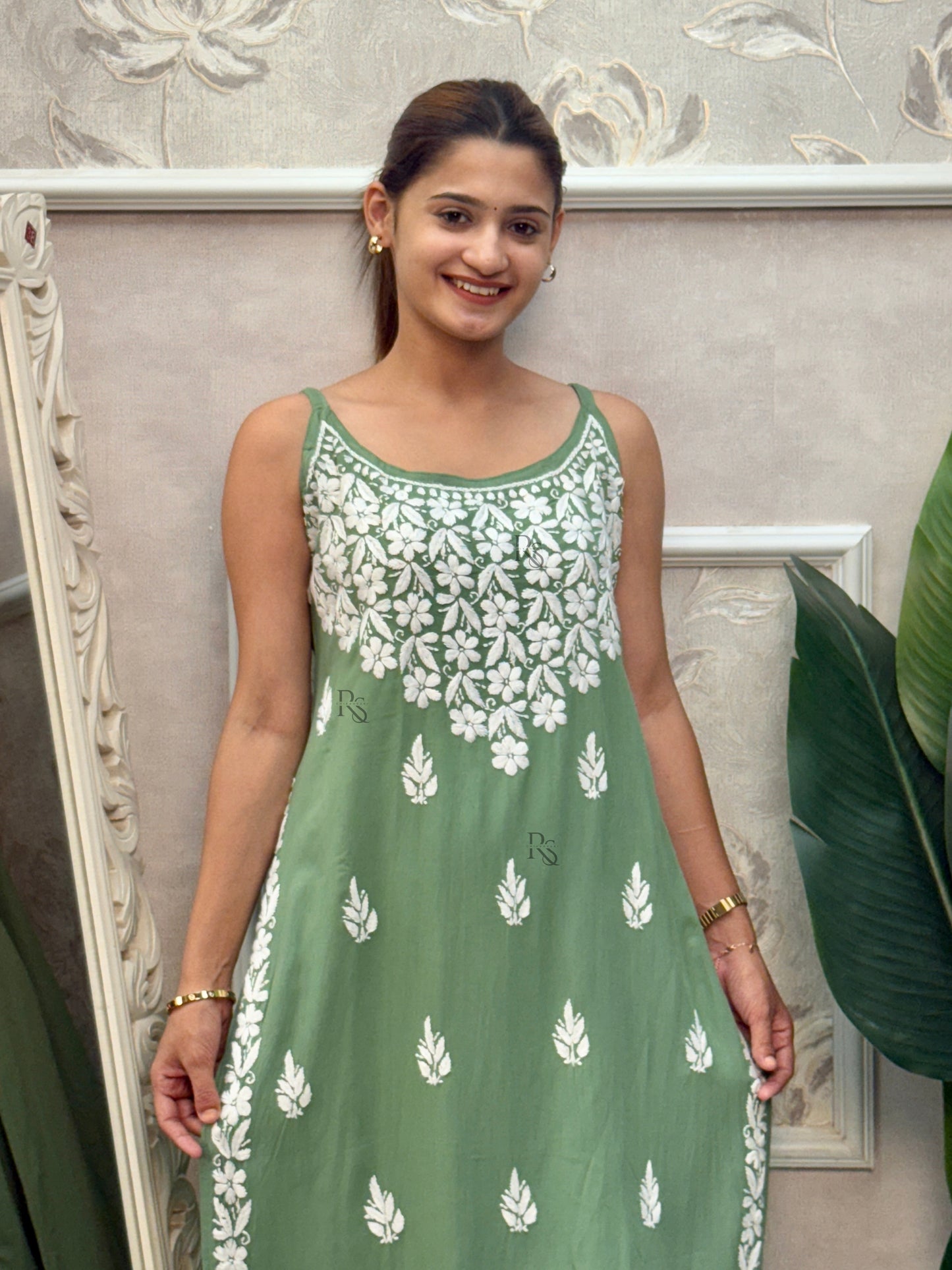 Sage green sleeveless Lucknow Chikankari rayon kurta and pant set with white hand embroidery.