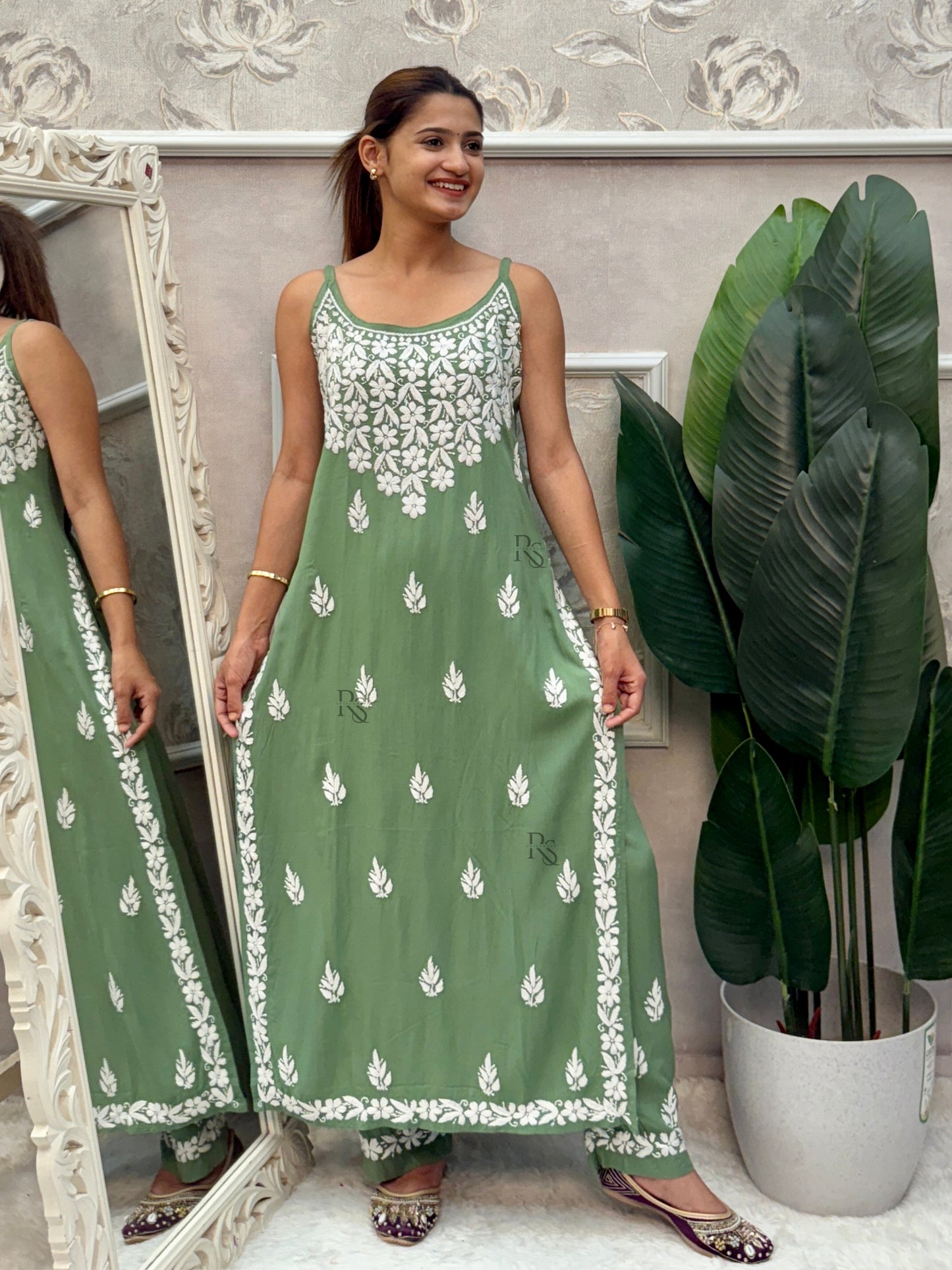 Sage green sleeveless Lucknow Chikankari rayon kurta and pant set with white hand embroidery.