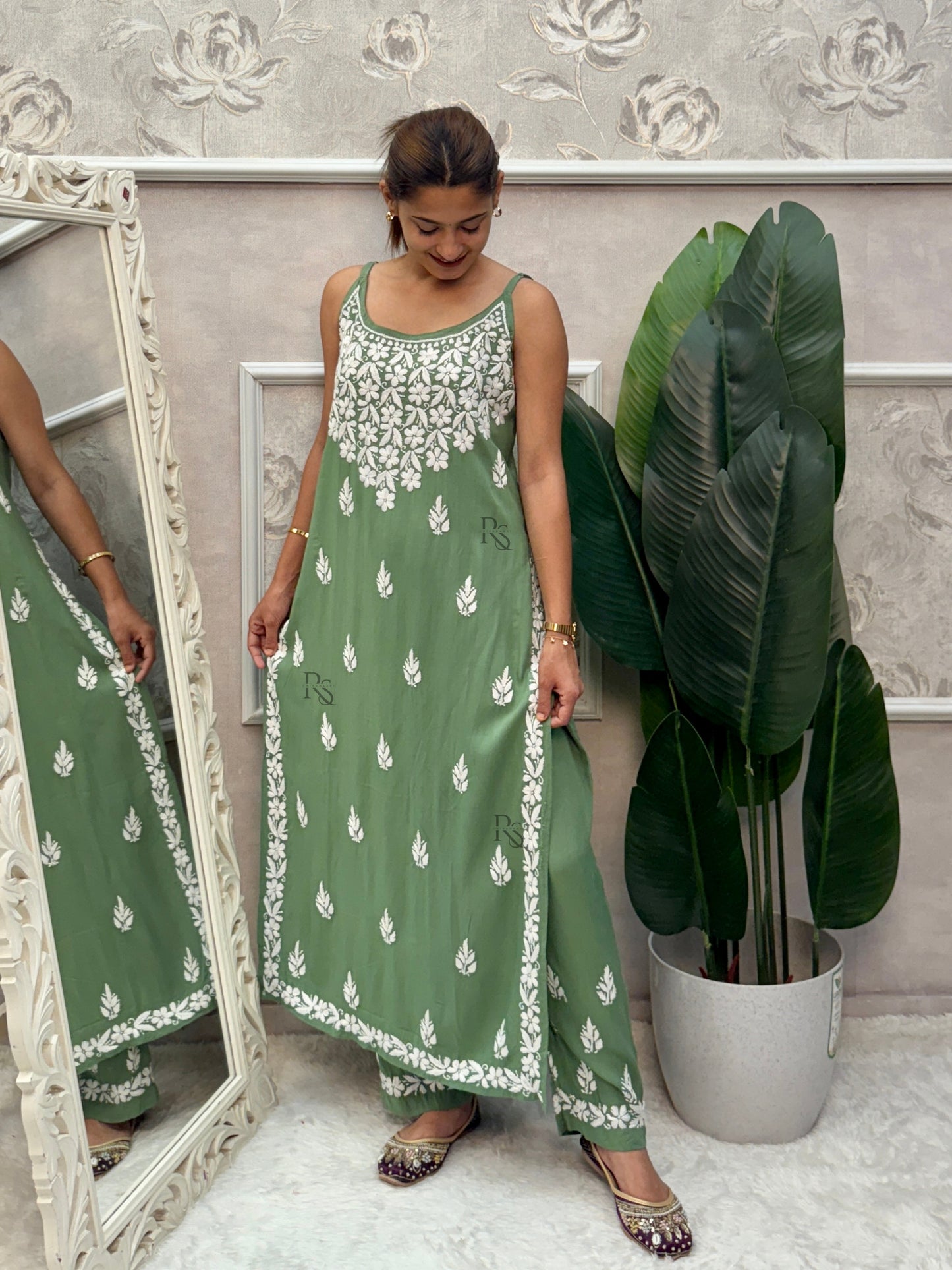 Sage green sleeveless Lucknow Chikankari rayon kurta and pant set with white hand embroidery.