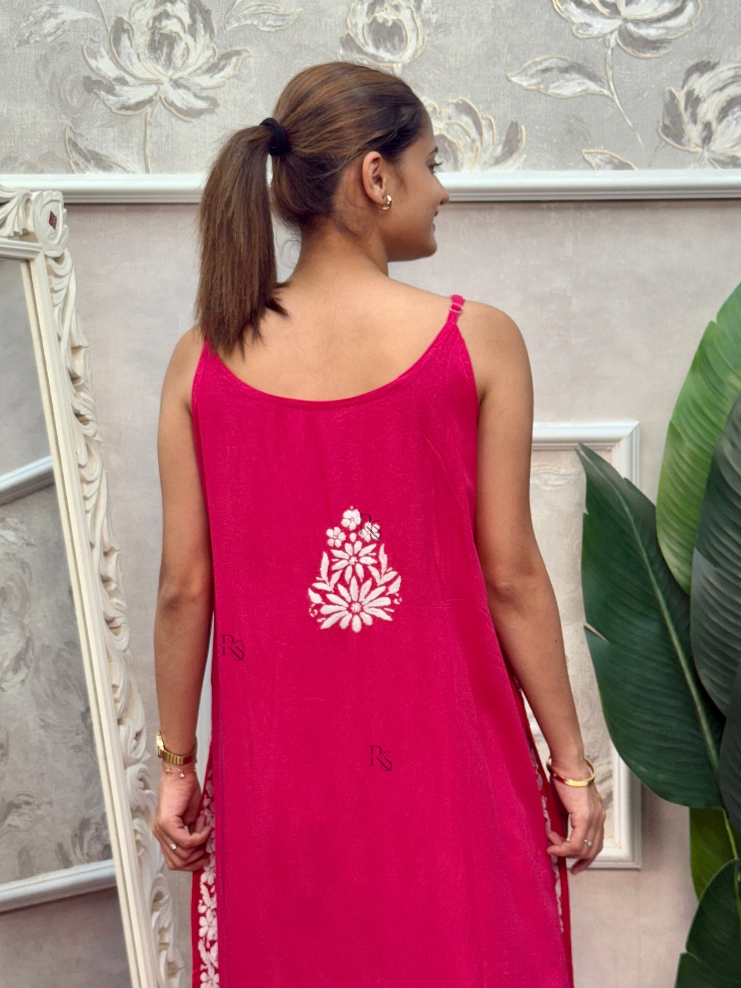 Rani pink sleeveless Lucknow Chikankari rayon kurta and pant set with white hand embroidery.