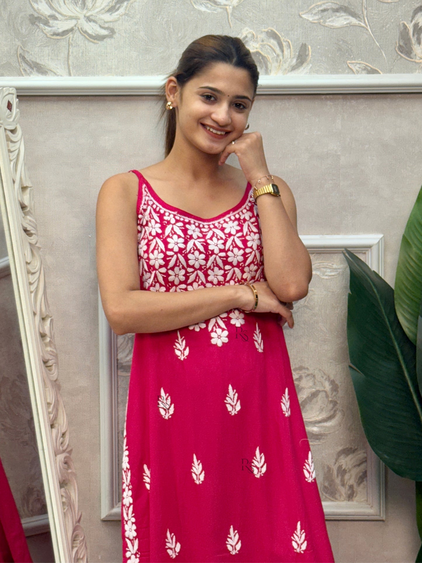 Rani pink sleeveless Lucknow Chikankari rayon kurta and pant set with white hand embroidery.