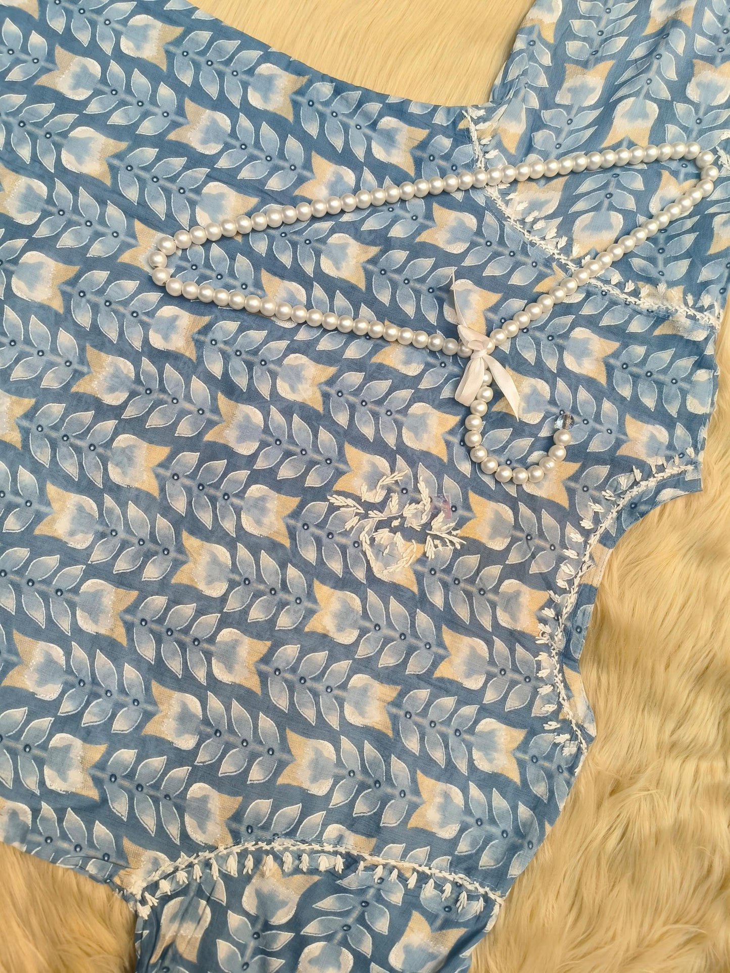 Flat lay of powder blue printed mulmul chikankari kurta with hand embroidery