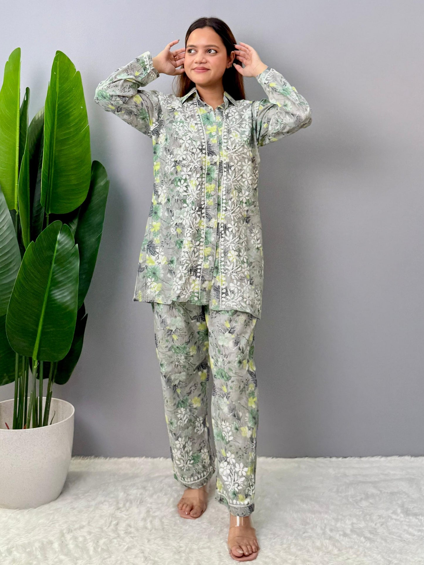 Model wearing a grey printed mulmul chikankari co-ord set with green and yellow floral design, featuring a long shirt-style kurta and matching pants.