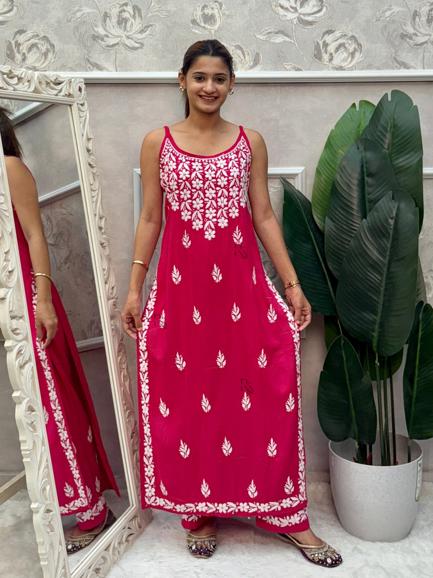 Rani pink sleeveless Lucknow Chikankari rayon kurta and pant set with white hand embroidery.