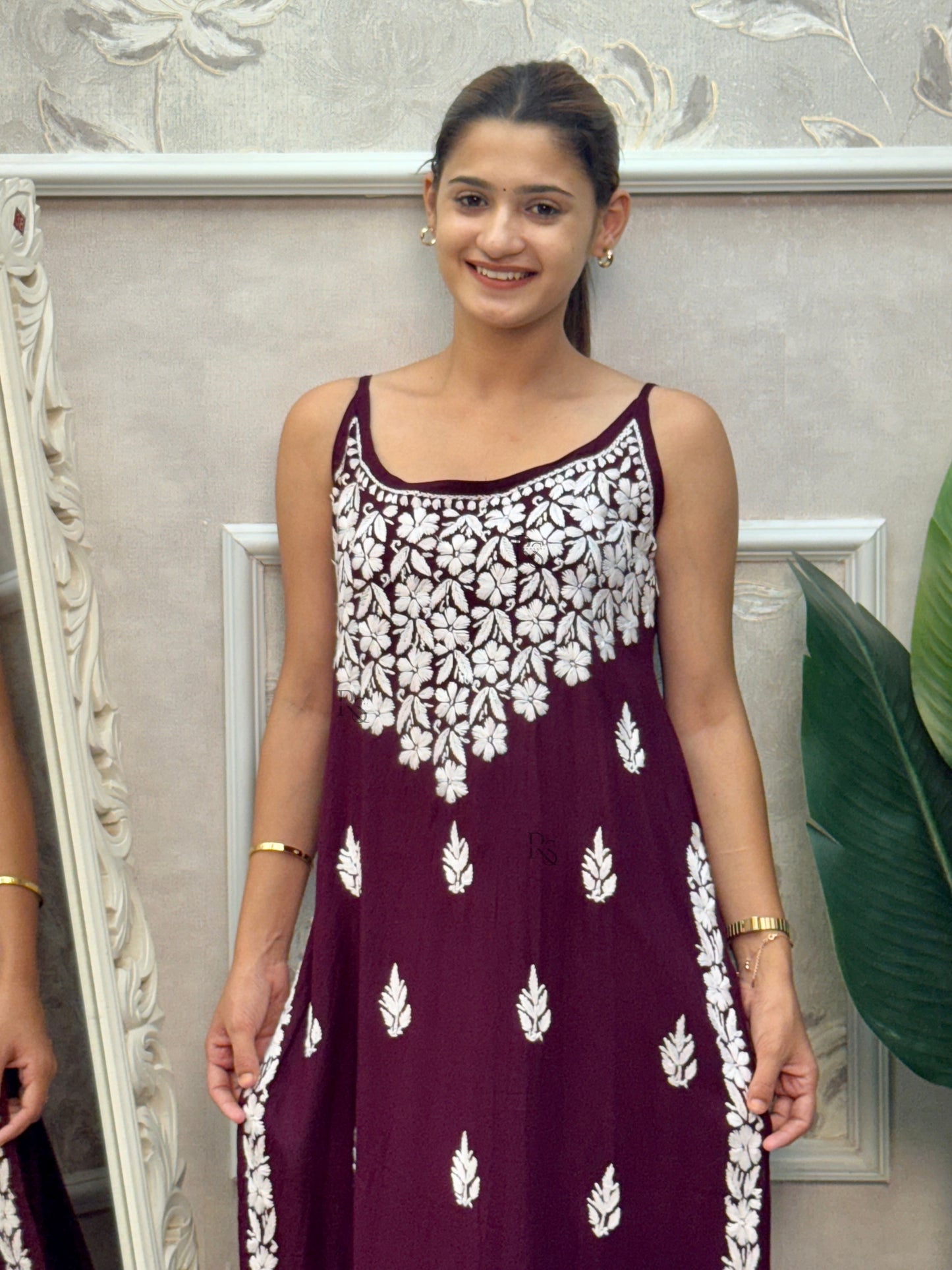 Wine sleeveless Lucknow Chikankari rayon kurta and pant set with white hand embroidery.