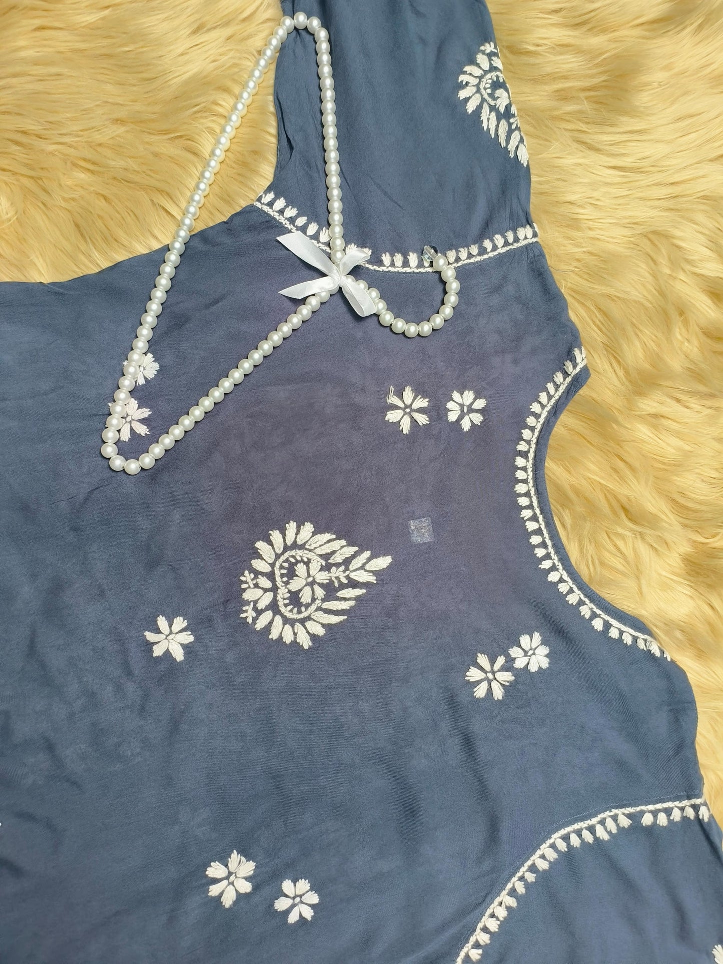 Indigo blue rayon chikankari kurta and pant set with white floral embroidery displayed on fur background
